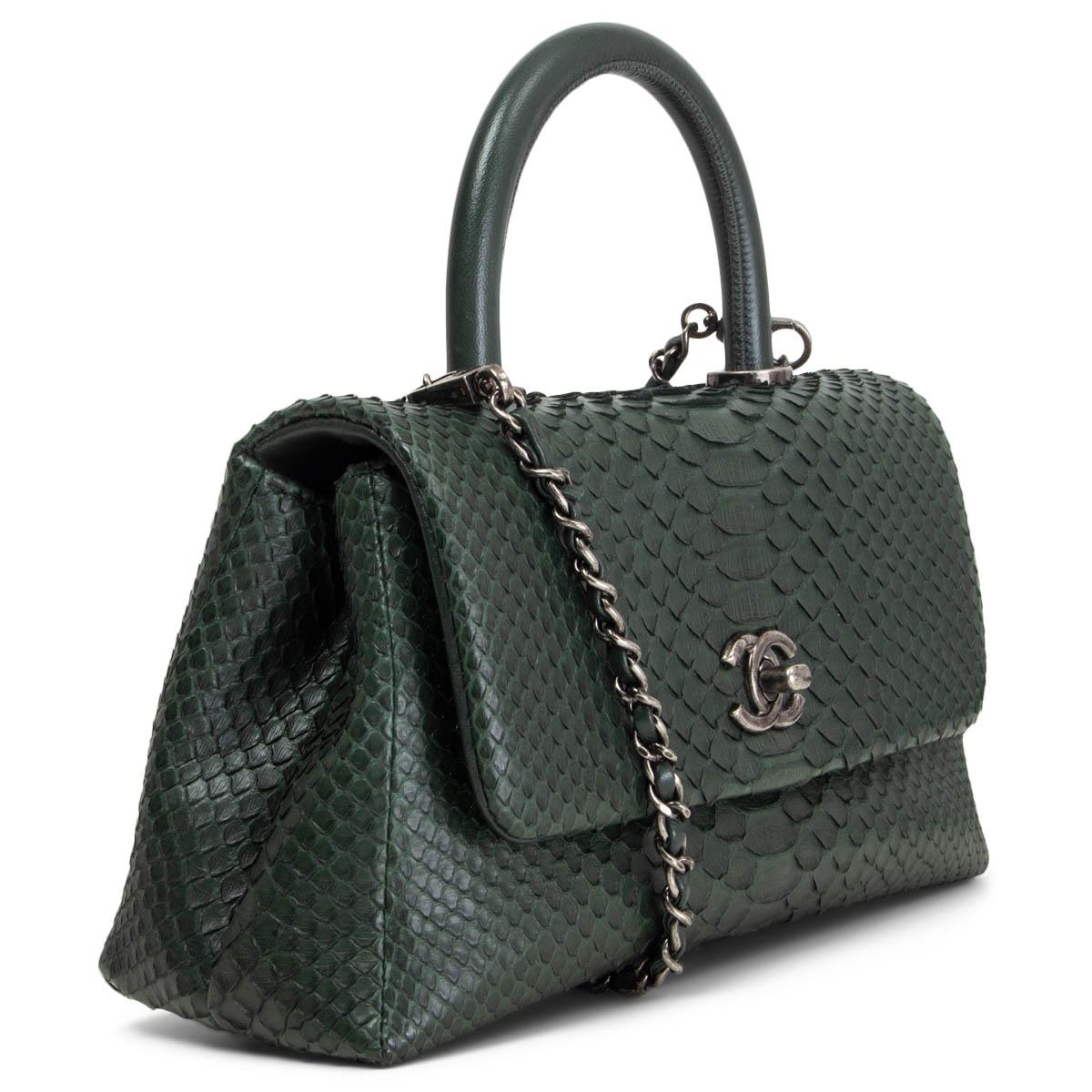 100% authentic Chanel 2016 Coco Handle Small Flap bag in dark green python. Opens with a gunmetal CC turn-lock to a dark green lambskin lined interior with one zip pocket against th back and one open pocket in the middle. Comes with a detachable