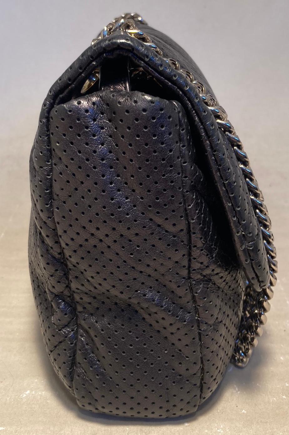 Chanel Perforated Drill Flap Classic in excellent condition. Black perforated distressed leather exterior trimmed with silver chain shoulder strap and silver & gold hardware. Front mademoiselle twist lock closure opens via single flap to grey satin