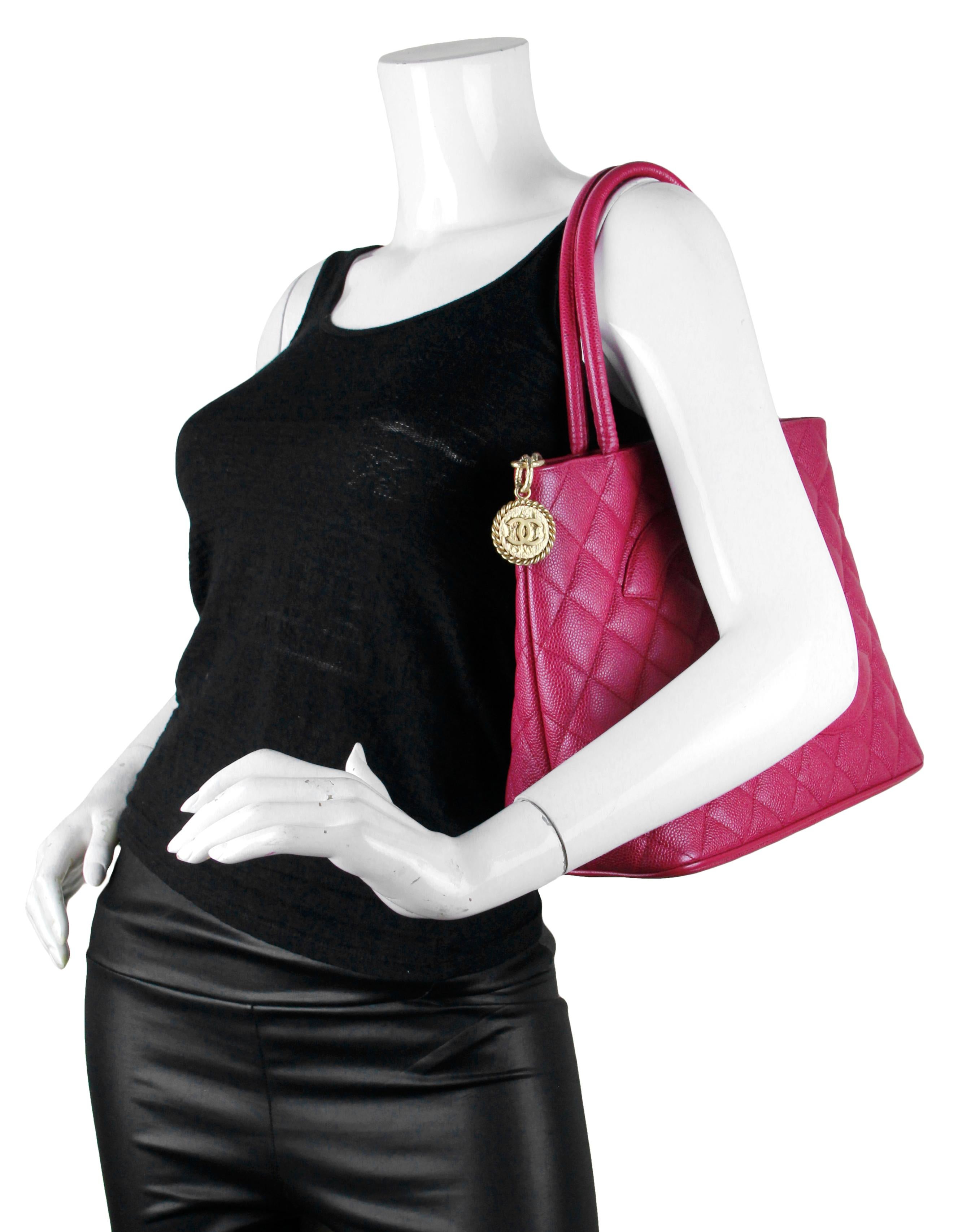 Chanel Dark Pink Caviar Leather Medallion Tote Bag 

Made In: Italy
Year of Production: 2000-2002
Color: Dark pink
Hardware: Goldtone
Materials: Caviar Leather
Lining: Leather
Closure/Opening: Top zip
Exterior Pockets: One flat pocket
Interior