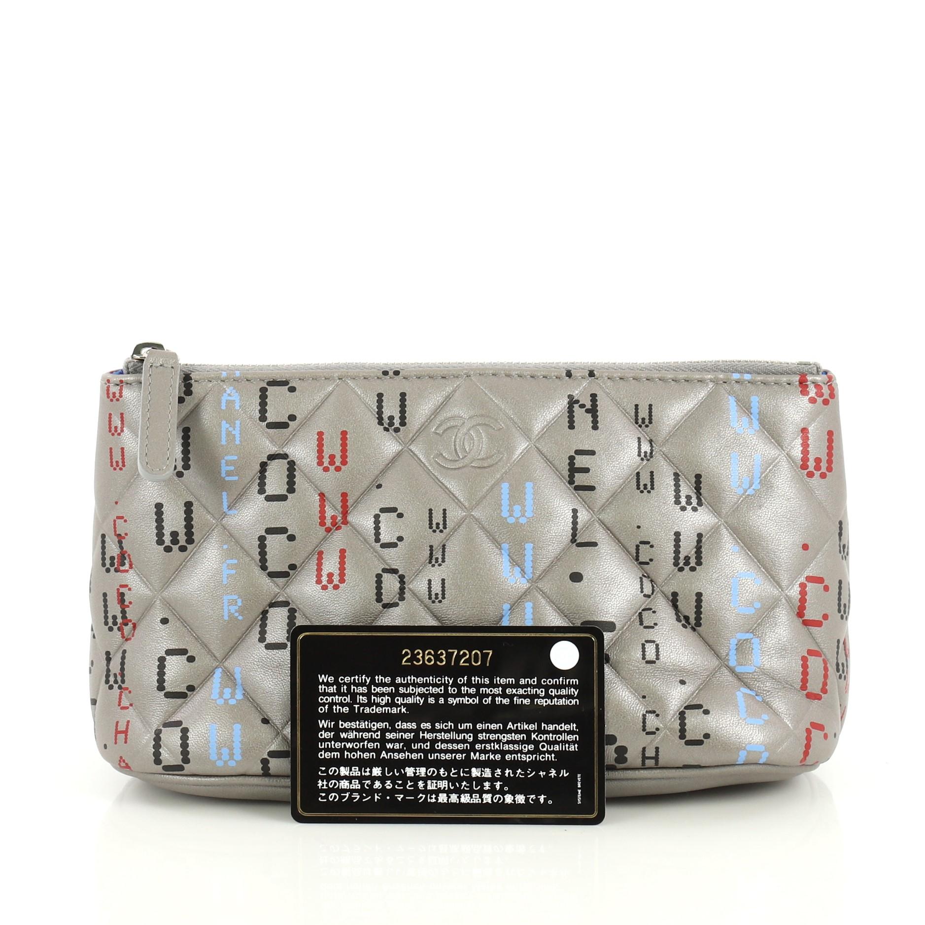 This Chanel Data Center Zip Pouch Quilted Printed Lambskin Small, crafted from gray leather, features multicolored print and silver-tone hardware. Its zip closure opens to a blue nylon interior. Hologram sticker reads: 23637207. 

Condition: