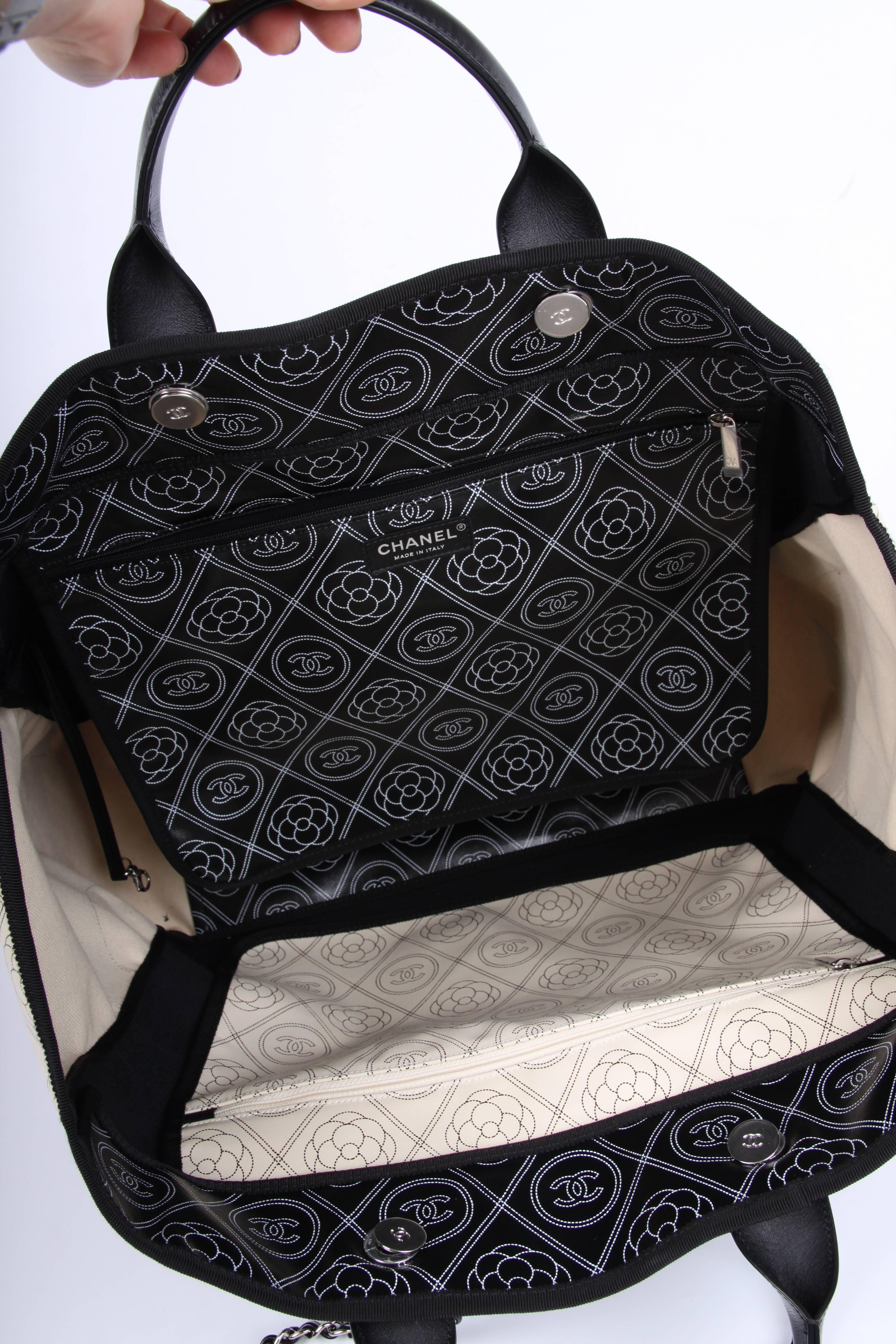 
Chanel never disappoints! Look at this Deauville Shopper in black and white! Wonderful!

A very large size, anything will fit into this bag. Crafted from black/white coated canvas covered with CC logos and camellias. The word CHANEL has been