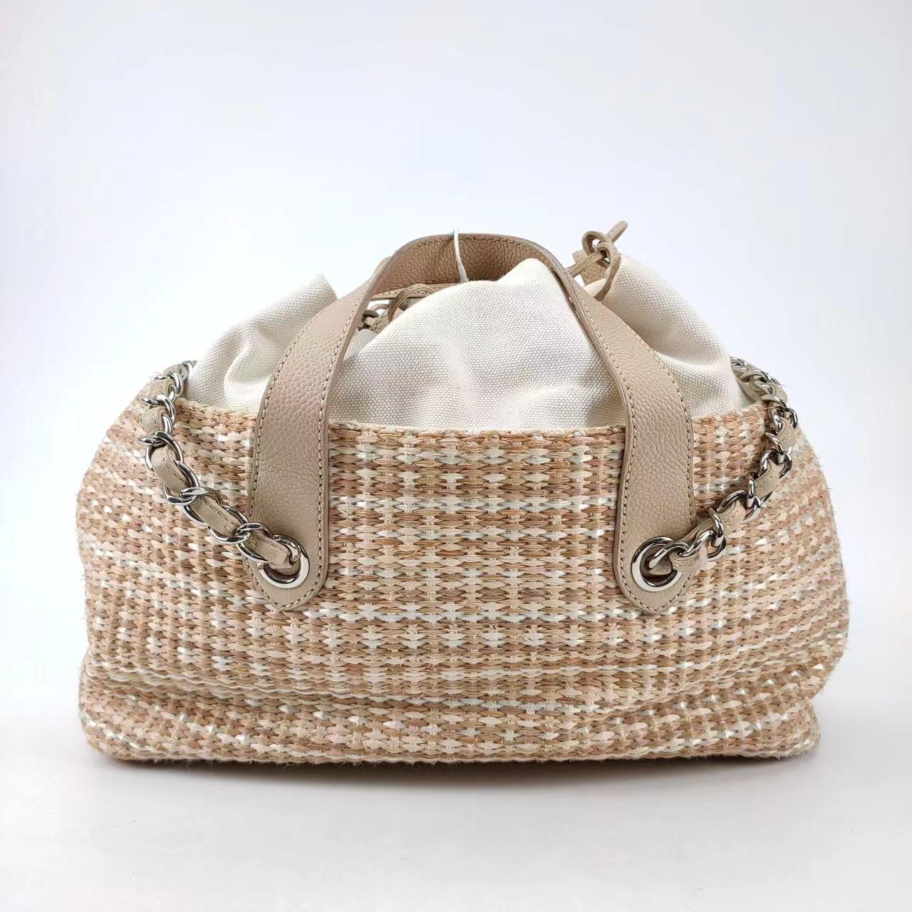 Chanel Deauville Chain Shoulder Bag Beige Raffia and Tweed
 These are professional photos of the actual bag offered by Luxbags.
 Be fashionably fun this season, with Chanel's Deauville Chain Shoulder Bag. Made of beige raffia, tweed, and canvas, it