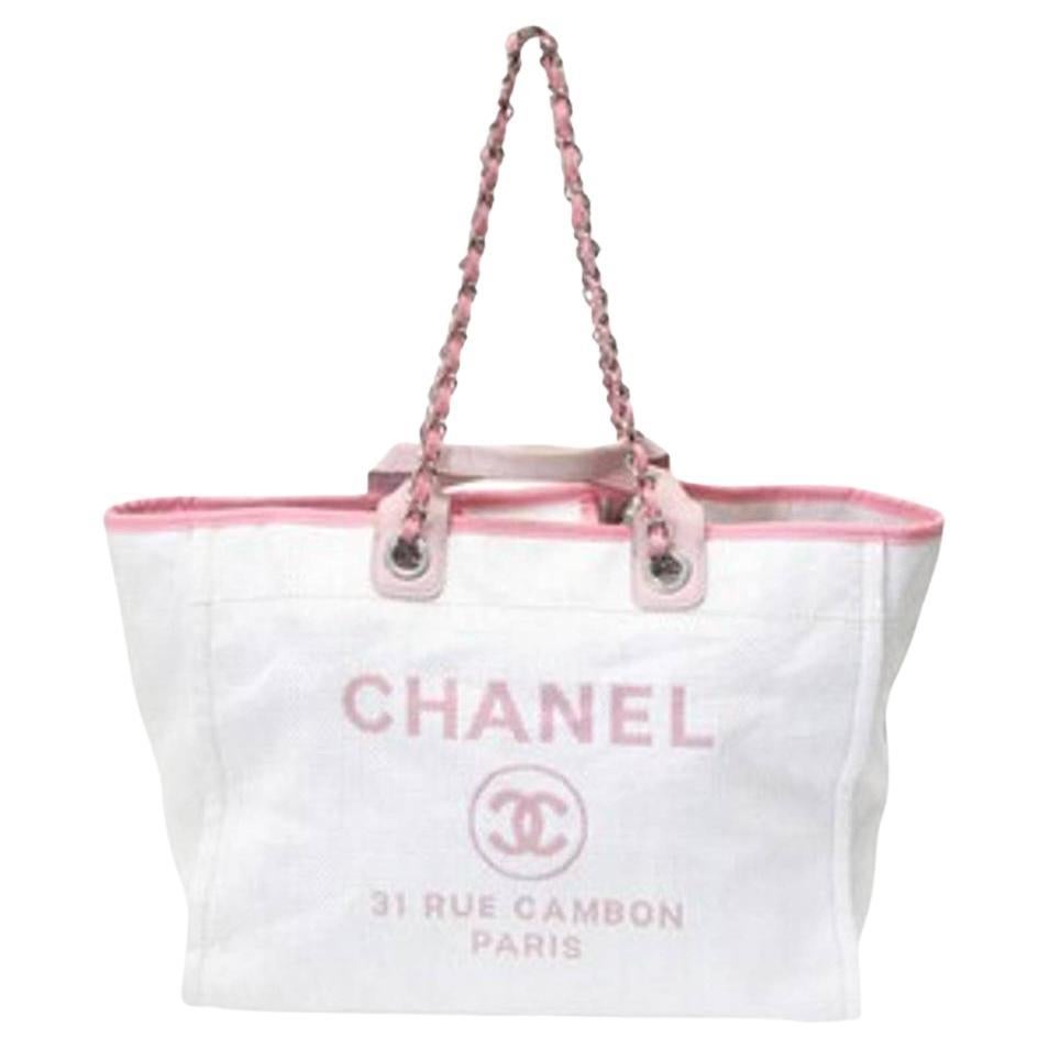 Here is a signature masterpiece by the world-famous CHANEL with elegant Mixed Fibers Calfskin Deauville Tote Pink travel bag. This stylish handbag is crafted of fine mixed fibers in pink with an embroidered Chanel Rue Cambon Paris logo. It features