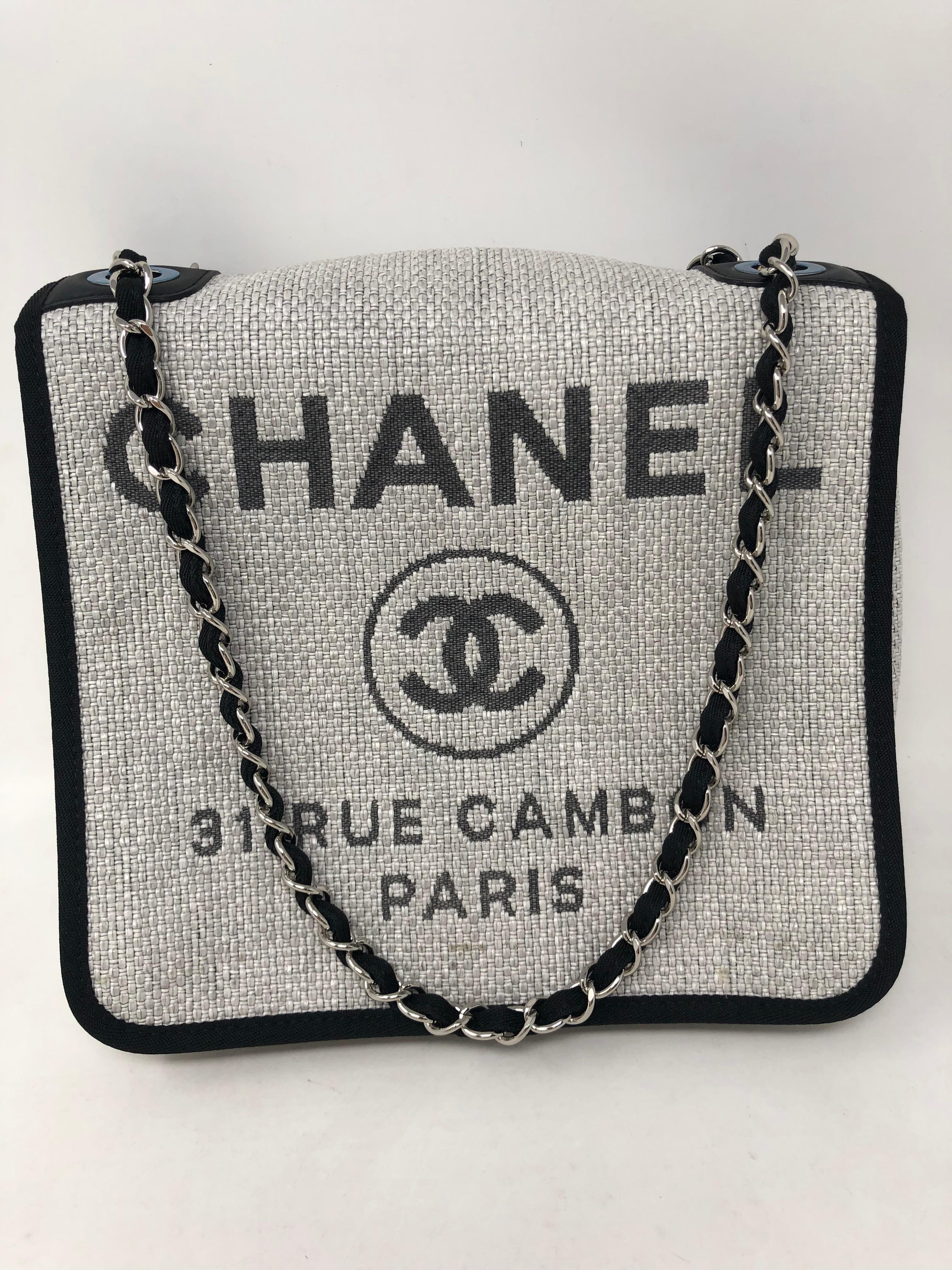 Chanel Deauville Messenger Bag in Grey Woven Straw Raffia. Small messenger with chain link shoulder straps. Can be worn 2 ways. New condition. Plastic still on hardware. Includes authenticity card. Guaranteed authentic. 