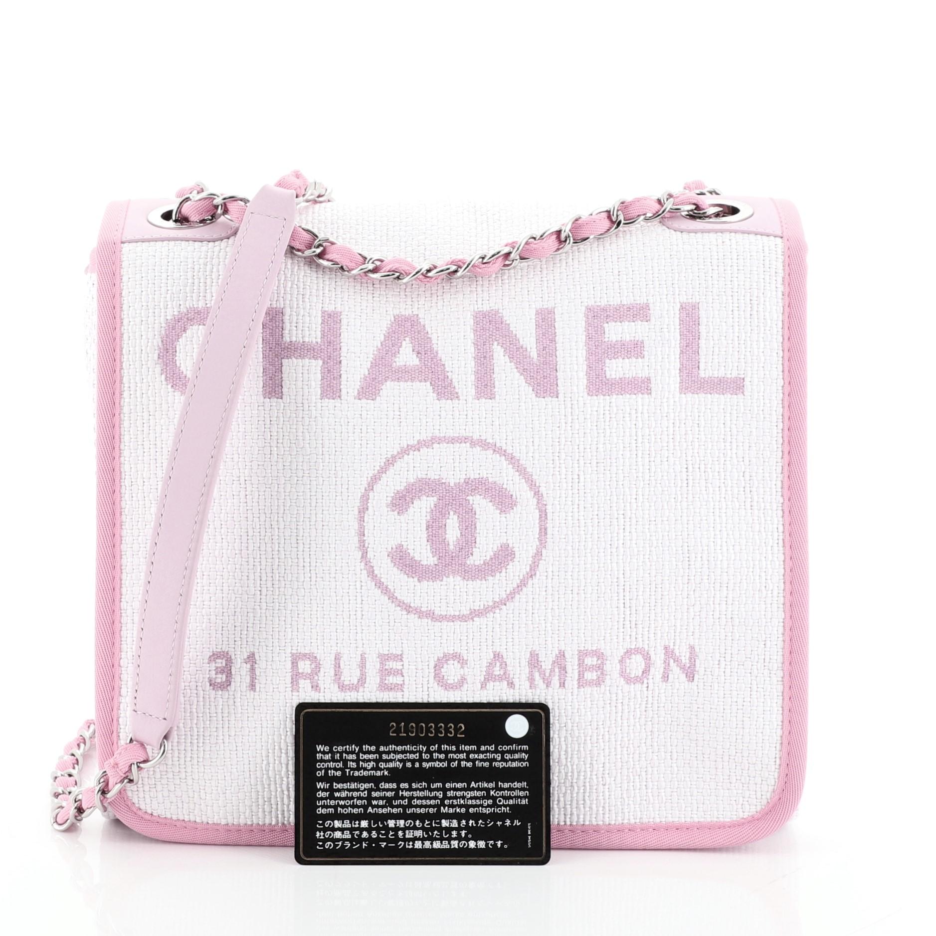 
This Chanel Deauville Messenger Bag Raffia Small, crafted in white and pink raffia, features woven-in fabric chain strap with shoulder pad, fabric trim, Chanel logo and flagship store address on flap, and silver-tone hardware. Its magnetic snap