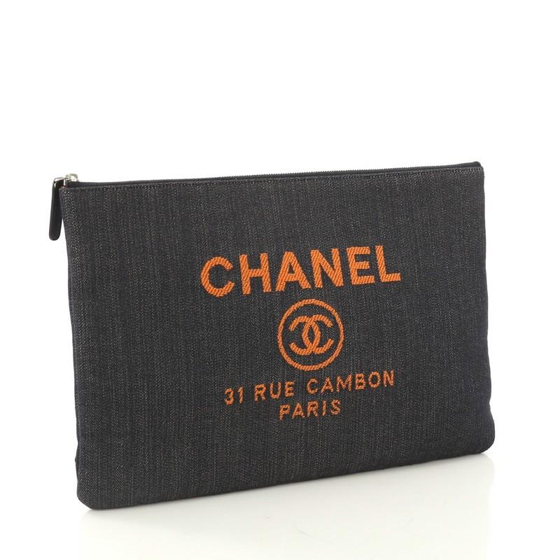 This Chanel Deauville Pouch Denim Large, crafted in blue denim, CC logo with Chanel's famous Parisian store address on front and silver-tone hardware. Its zip closure opens to an orange nylon interior. Hologram sticker reads: 23874459. 

Condition: