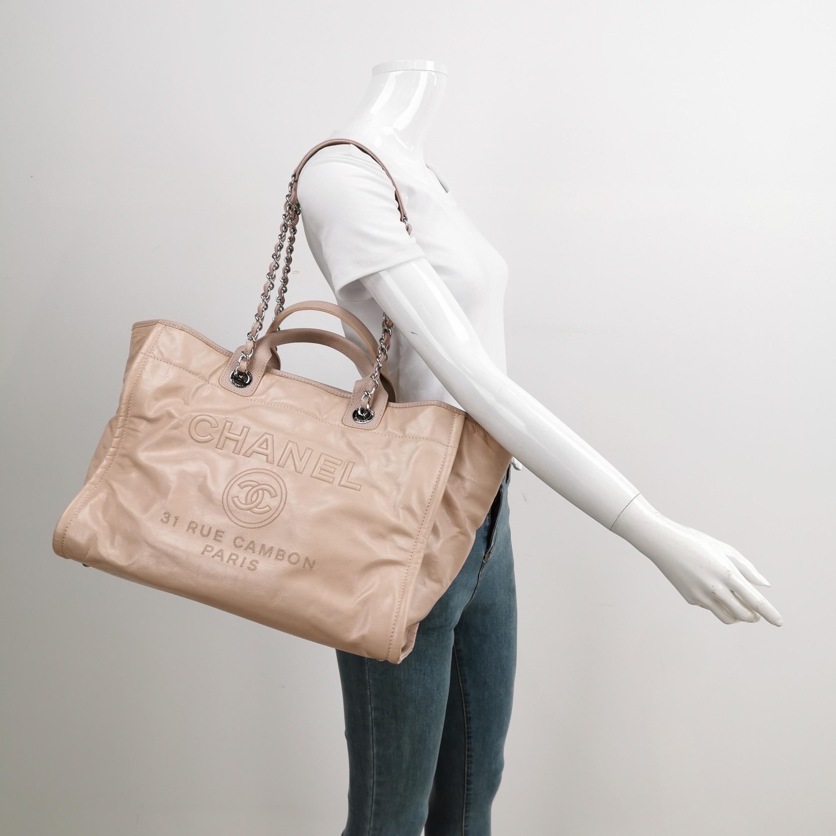 Chanel Deauville Tote Medium Pink Leather Top Handle Leather Chain Straps
These are professional photos of the actual bag offered by Luxbags.
The Chanel Deauville Tote, named after the French seaside resort, is a must-have for summer, combining