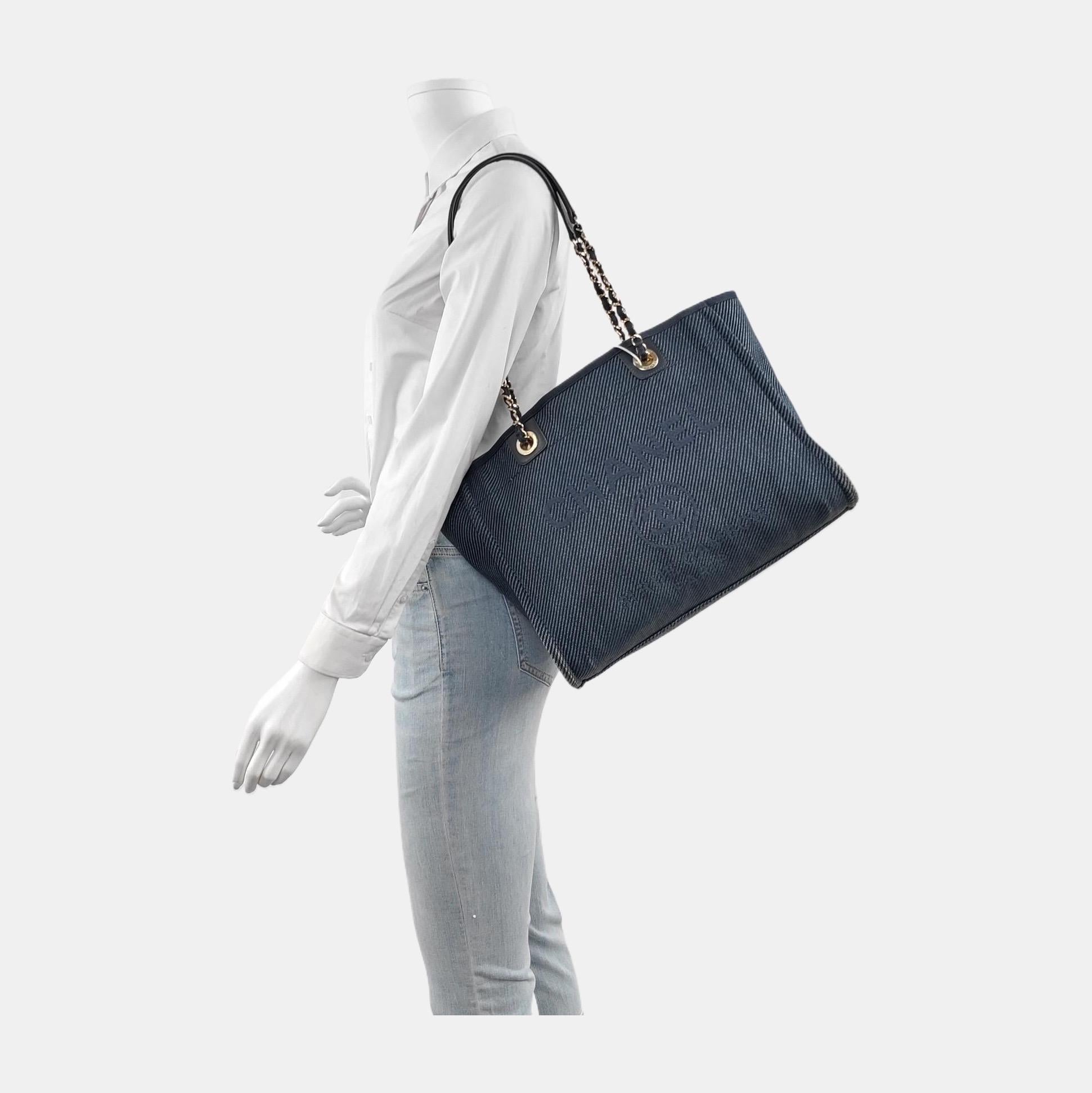 The Chanel Deauville Tote bag is a stylish accessory for everyday use. Crafted from durable denim, this tote is perfect for all season wear. Despite signs of use, this bag is in very good condition. Show off your effortless chic with the Chanel