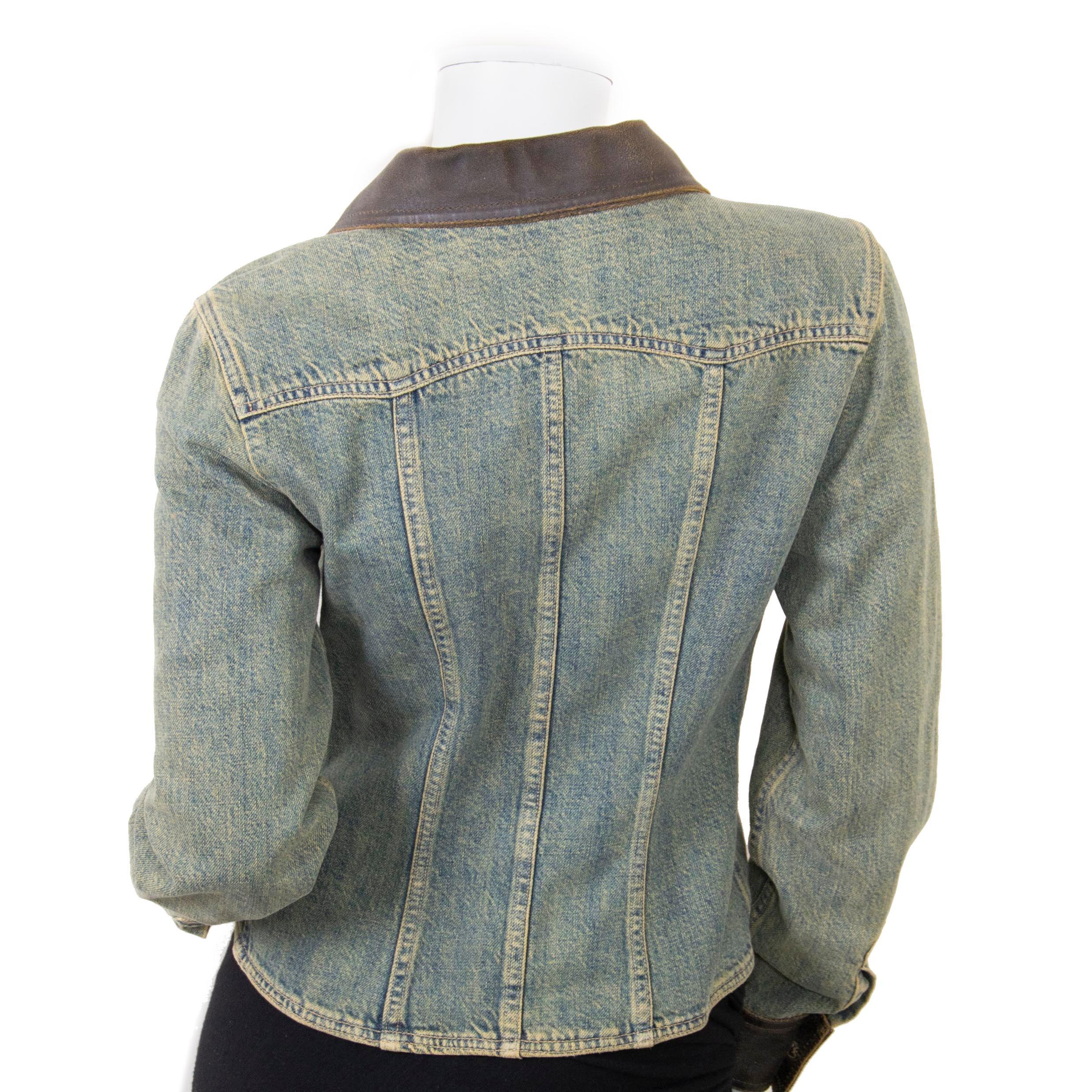 Stunning Chanel Denim Jacket with Leather Collar in a French size 38. This piece was part of the 2000 A/W collection. 
Distressed denim look and aged leather details. 
