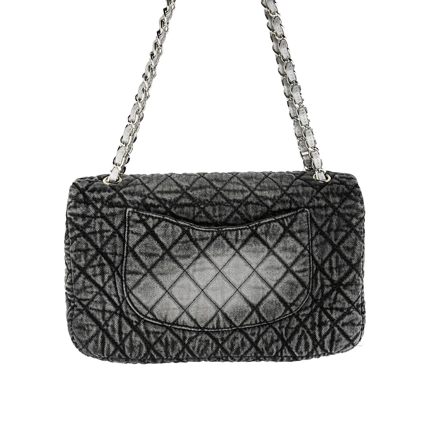 From the Chanel Cruise 2020 Bag Collection. This handbag is crafted of diamond quilted denim in gray and black. The shoulder bag features a leather threaded silver chain link shoulder strap, a rear flat pocket, and a polished silver Chanel CC turn