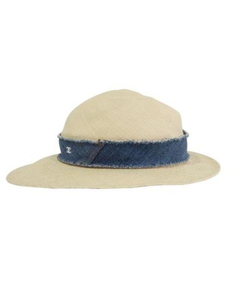 Stylishly beat the summer heat with Chanel's straw hat. It comes in a classic light beige color adorned by denim at the base, featuring the brand's CC logo at the front making it a staple addition to your accessories collection. Pair with a summer