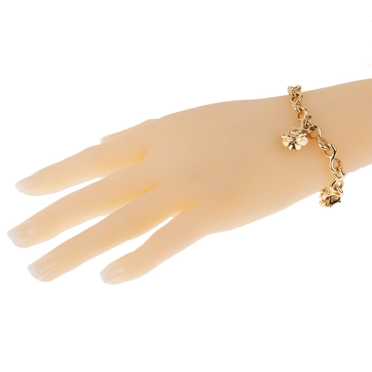 A fabulous authentic Chanel diamond yellow gold charm bracelet, featuring a diamond studded Number 5, a Camellia flower and a sleek “C”, all set upon an 18k solid Chanel yellow gold link bracelet.

Length: 7