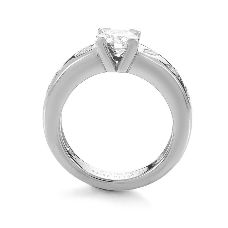 Impeccably crafted and charmingly decorated with 0.35ct of graceful diamonds, the smooth platinum body of this elegant ring from Chanel presents a worthy pedestal for the magnificent brilliant-cut central stone weighing approximately 0.90ct and