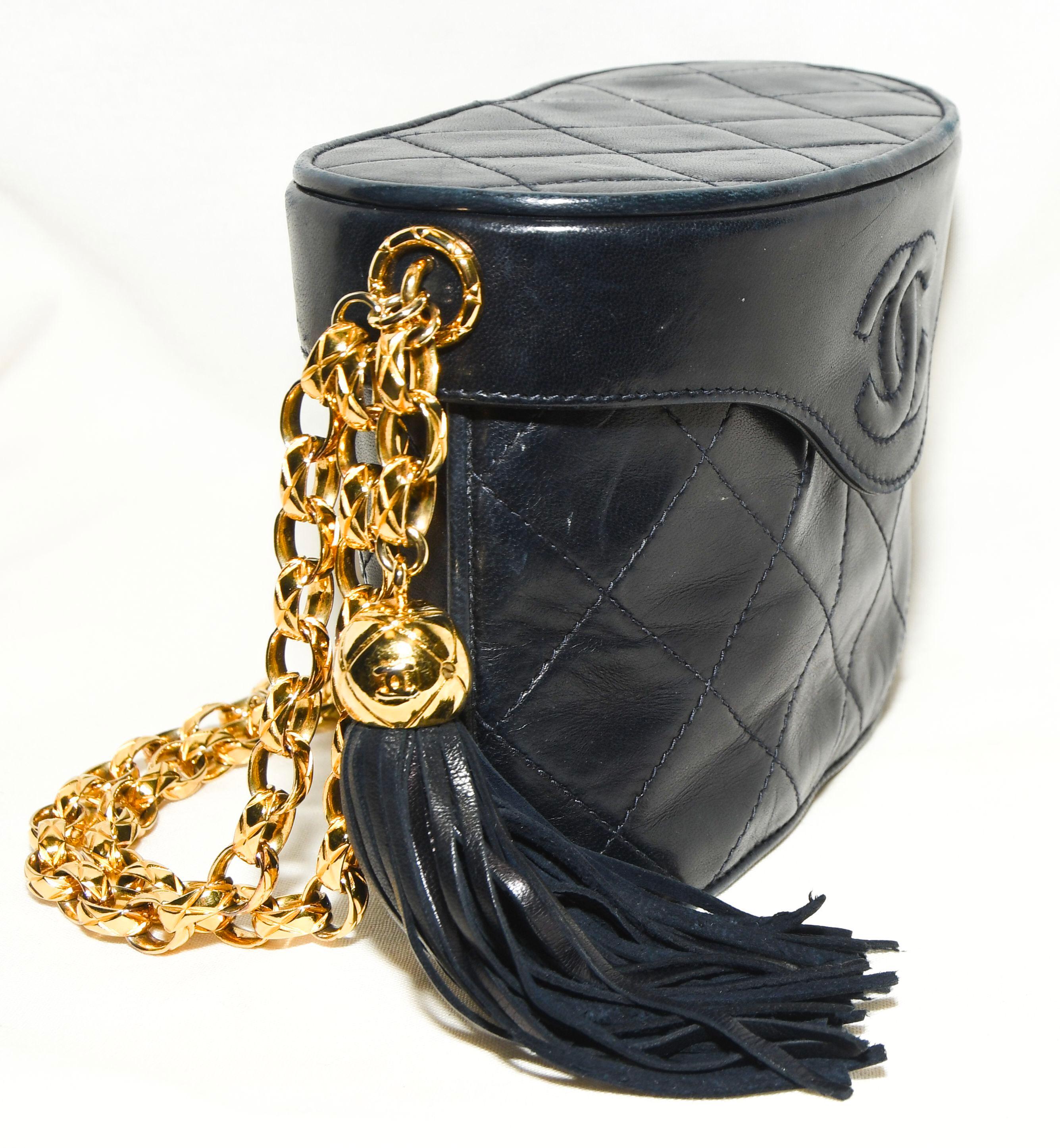 Chanel Binocular Bag crafted in diamond quilted lambskin leather. A long tassel hangs from the magnetic top flap in the shape of binoculars.  This bag is lined in black leather and includes single pocket on the interior.  A gold tone intricate