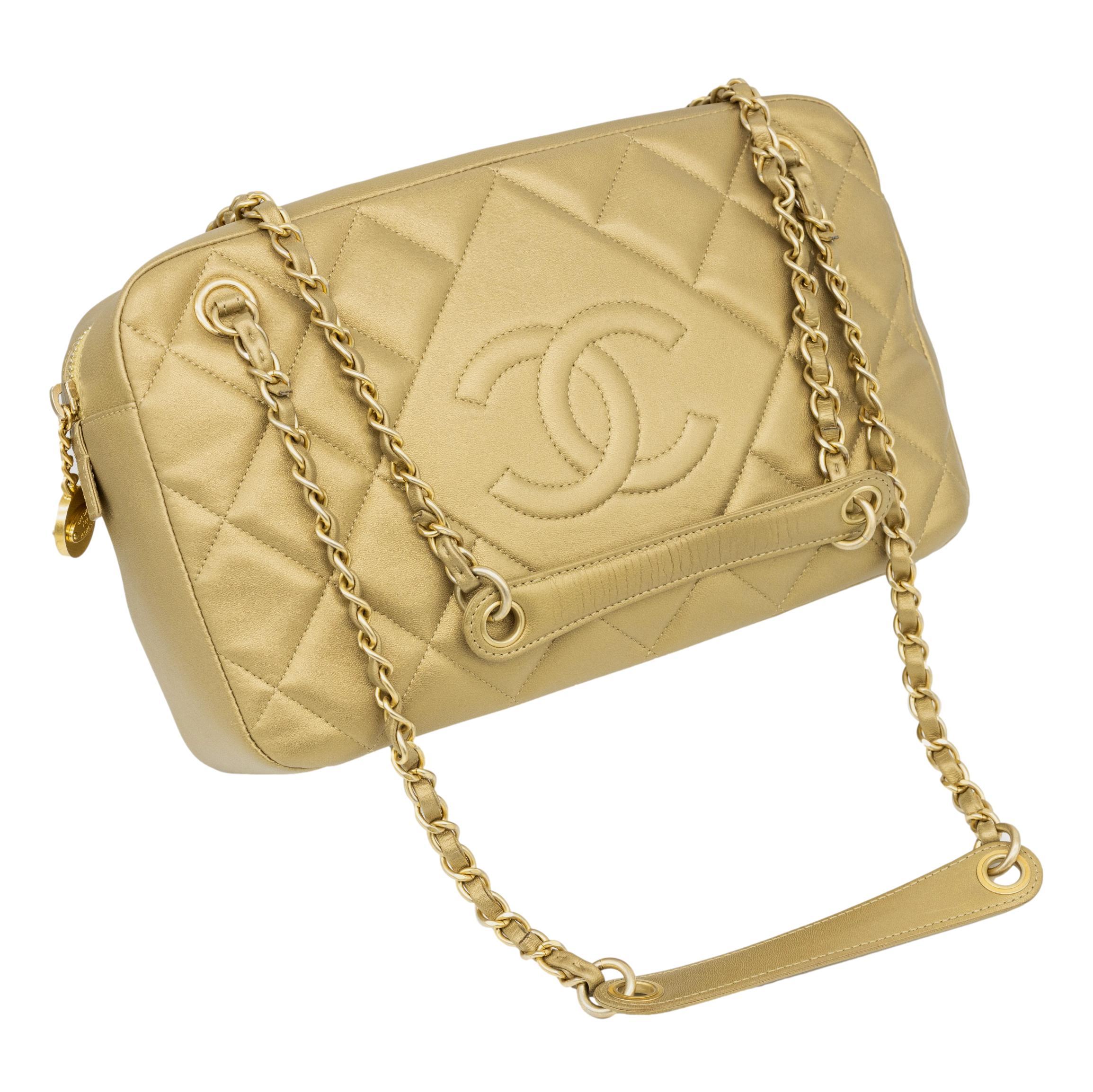 Chanel Diamond Quilted Metallic Gold Lambskin CC Camera Bag, 2014. This highly coveted and infamous crossbody camera bag was produced in 2014 baring a serial code of 