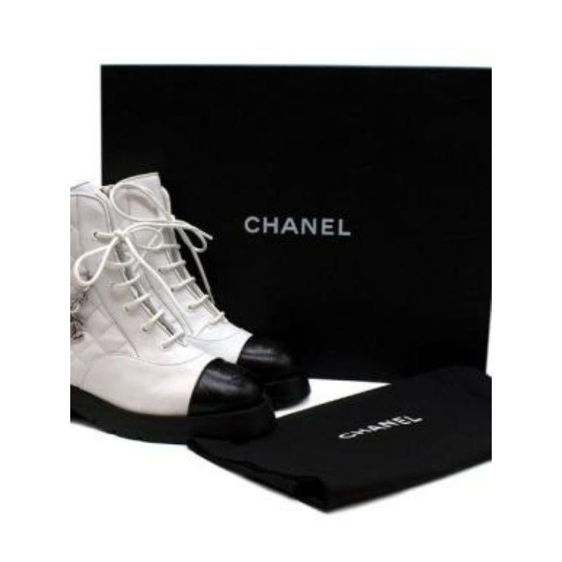 Chanel Diamond Quilted White Leather Biker Boots

- Smooth leather 
- Diamond quilted 
- Silver tone chain with woven leather 
- Embroidered CC 
- Lace up fastening 
- Small platform

Materials:
Leather 

Made in Italy 

PLEASE NOTE, THESE ITEMS ARE