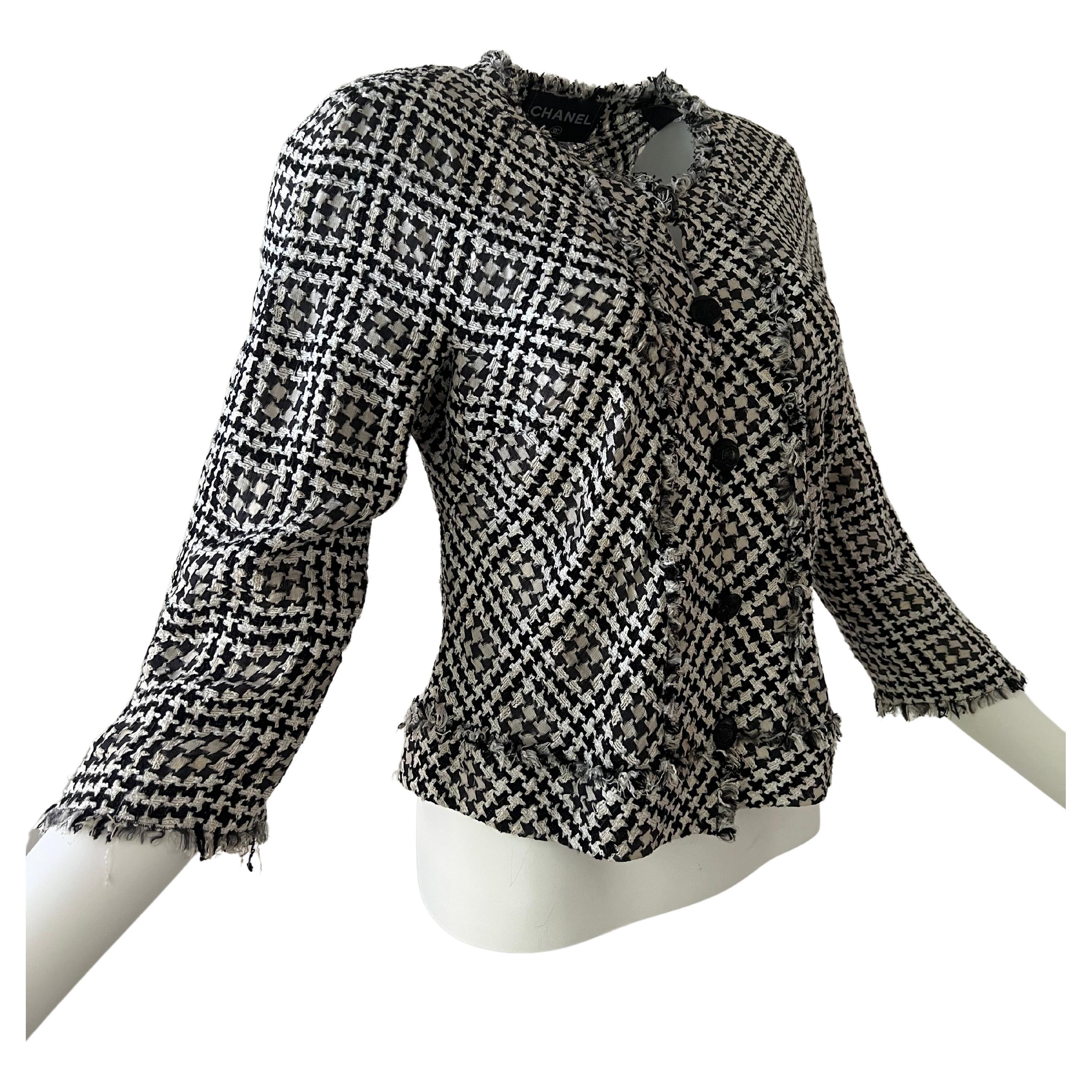 Chanel black and white checkered hounds tooth jacket, tweed braid on the front, at the waist and on the end of the sleeves. Five black Chanel buttons. Summer jacket without lining and very light. Made in France size 44.

