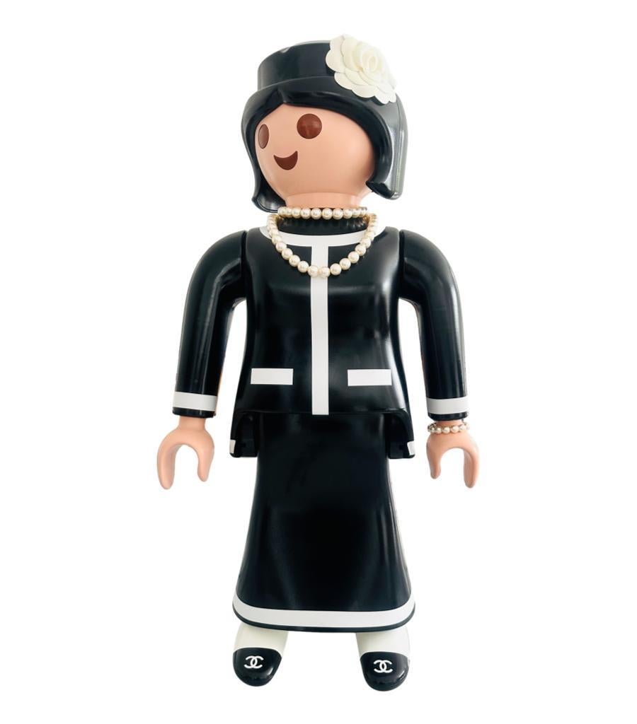 Rare Item - Chanel Doll Ltd Edition & Signed By Artist Pache

Playmobile oversized doll in black and white, dresses as Coco Chanel 

with removable pearl necklace and bracelet. 'CC' logo to each upper foot

and head having a 3D camellia