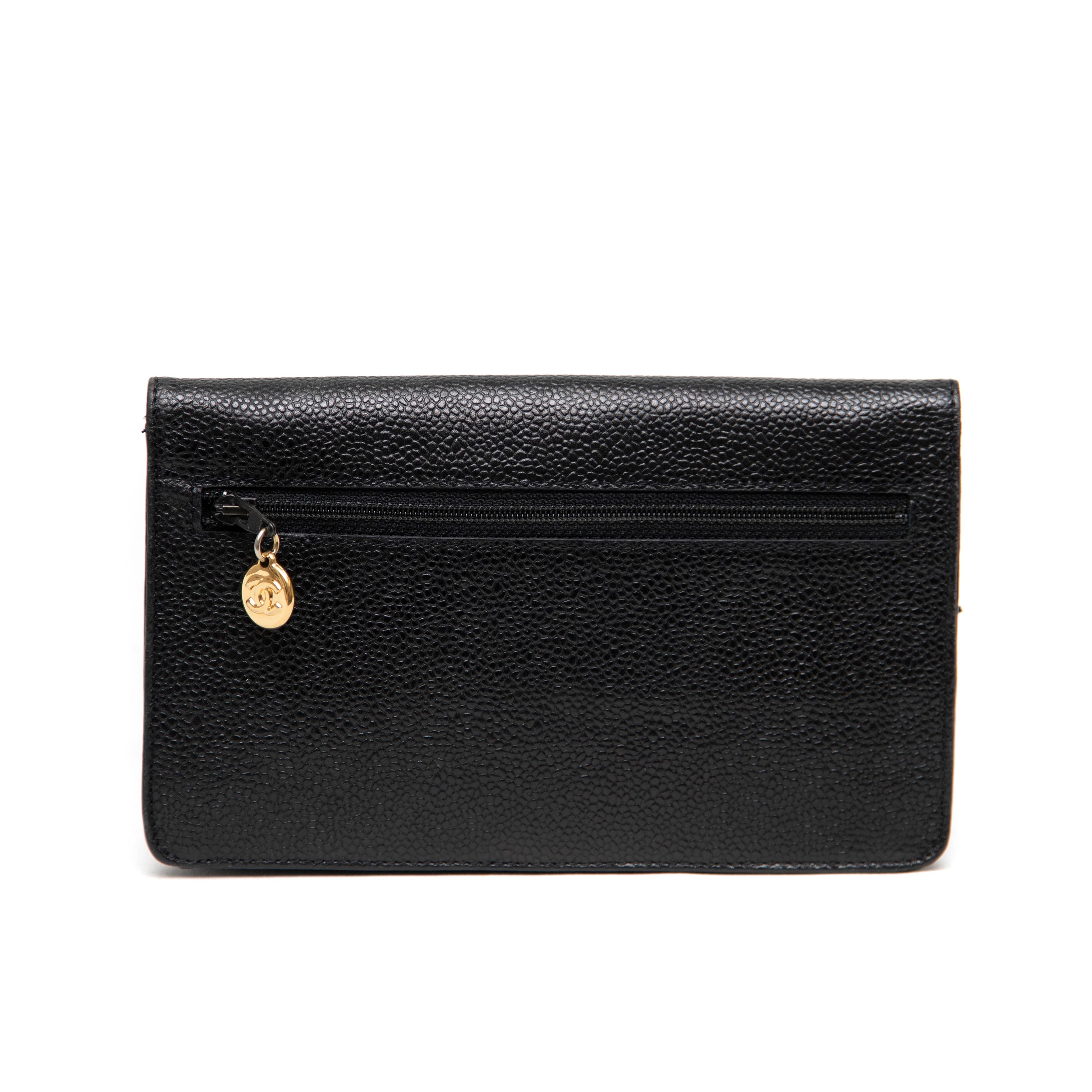 This elegant Chanel clutch in black caviar leather features the iconic Double C logo, making it a timeless and sophisticated accessory. Crafted in Italy, the clutch is in excellent used condition, showing minimal signs of wear. Its compact design