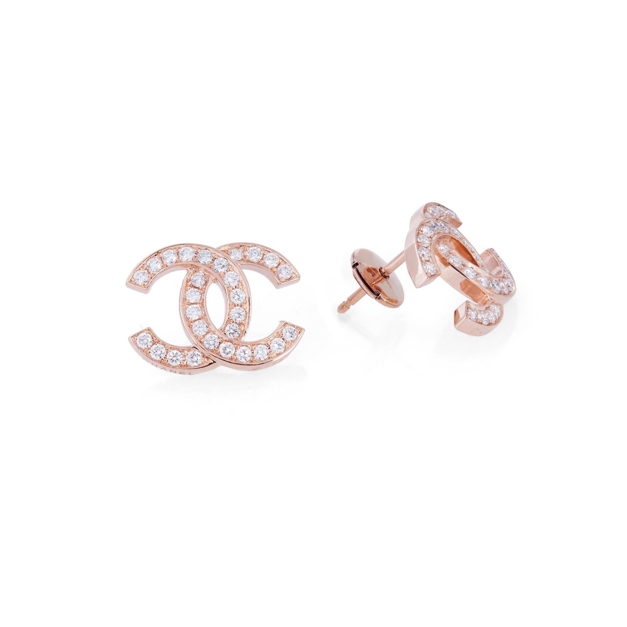 Authentic Chanel Double C earrings crafted in 18 karat rose gold and set with approximately .56 carats of high quality round diamonds.  The earrings measure .44 inches in length and .59 inches in width.  Signed Chanel, 750.  Earrings are not