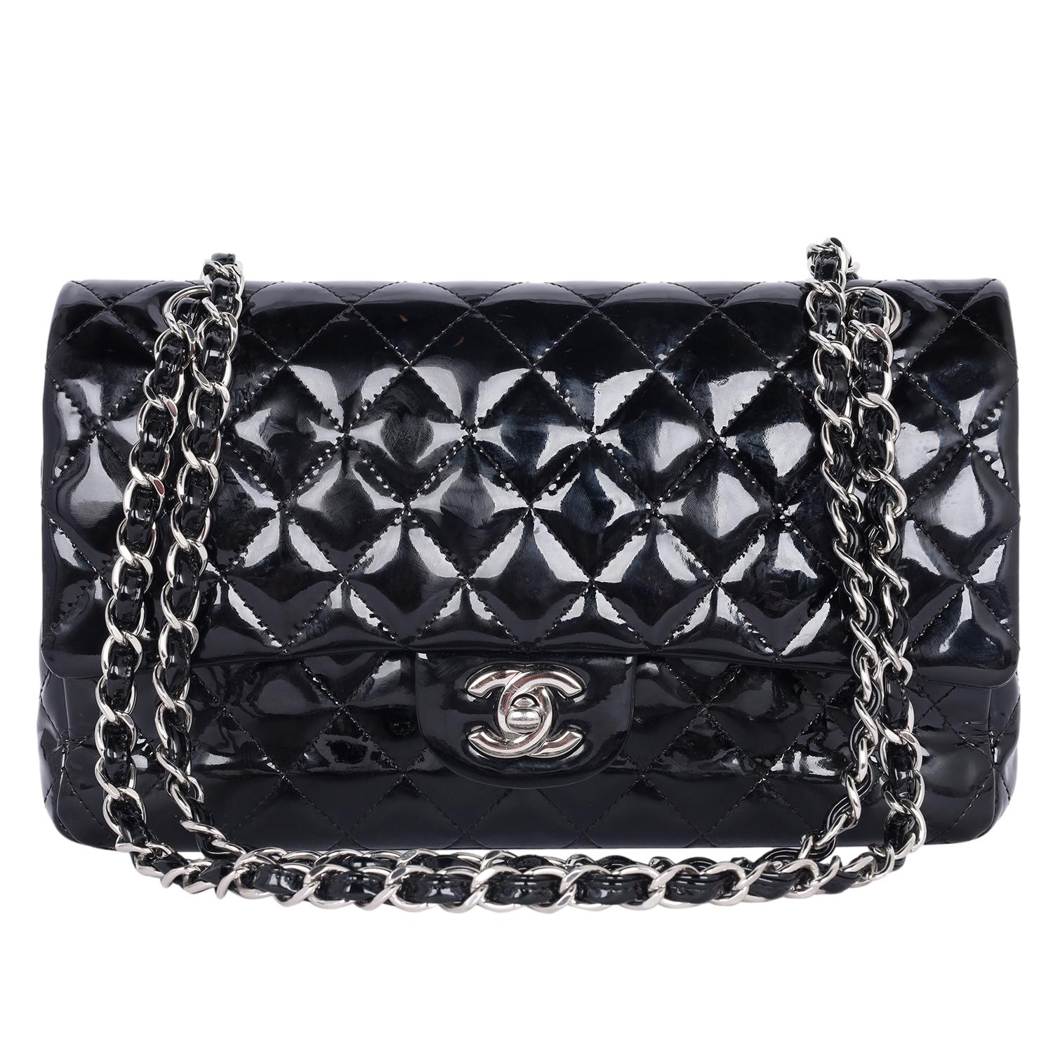 Authentic, pre-loved Chanel black CC double flap bag in patent leather. Features black patent leather, this luxurious, runway-ready bag features a woven-in chain strap, exterior back pocket, silver tone hardware accents. The turn-lock closure opens