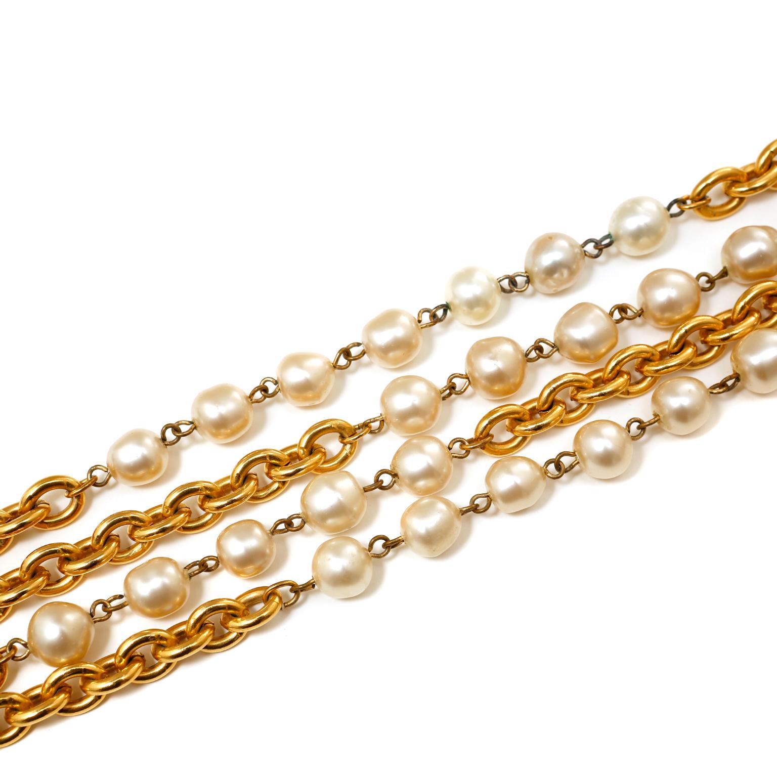 This authentic Chanel Double Chain Pearl Station Necklace is in excellent vintage condition from the 1980's.  24 karat gold plated link chains have dramatically long length.  Accented with groupings of irregularly shaped faux pearls.  Measures