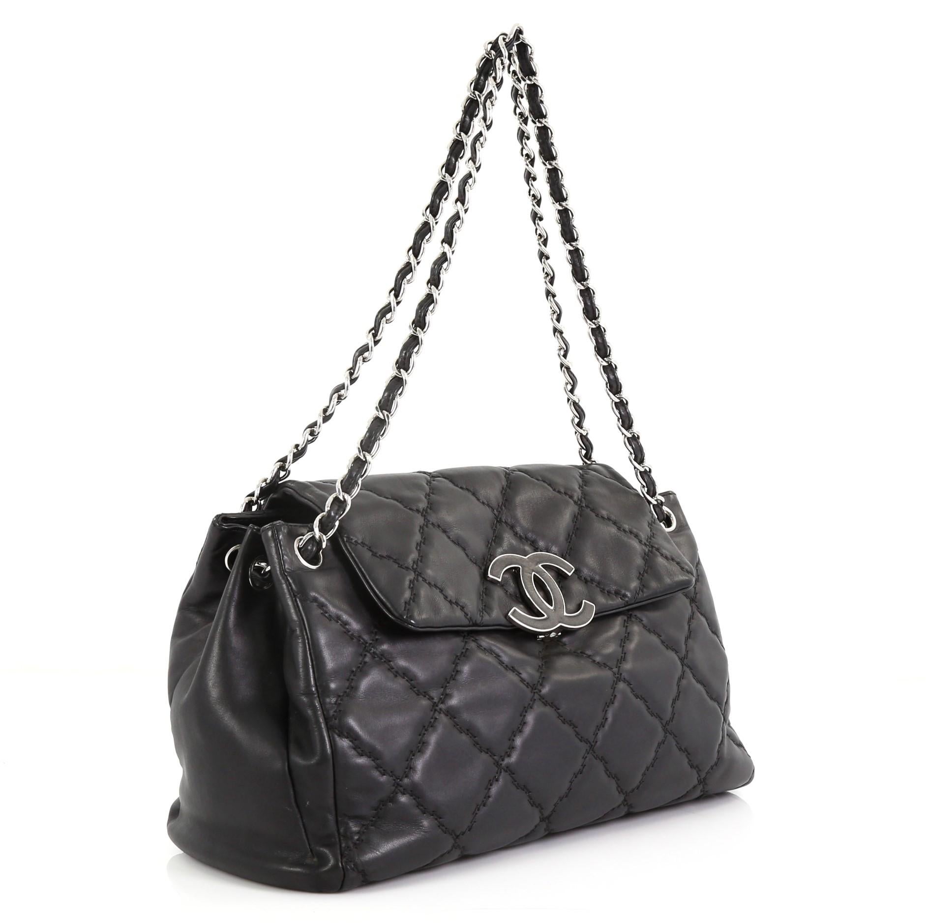 This Chanel Double Stitch Hamptons Accordion Flap Tote Quilted Calfskin Large, crafted from black leather with double stitched puffy quilting, features dual woven-in leather chain strap, top with large enamel CC tab closure, protective base studs