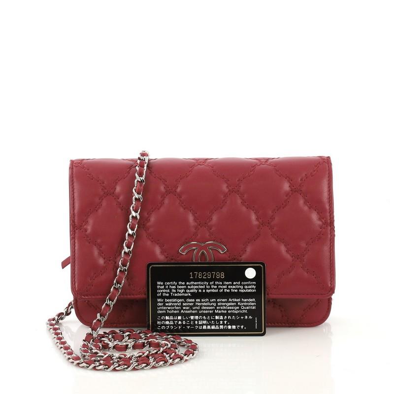 This Chanel Double Stitch Hamptons Wallet On Chain Quilted Leather, crafted from burgundy leather with double stitch puffy quilted detailing, features woven-in leather chain strap, unique enamel Chanel CC logo with a burgundy calfskin center, and