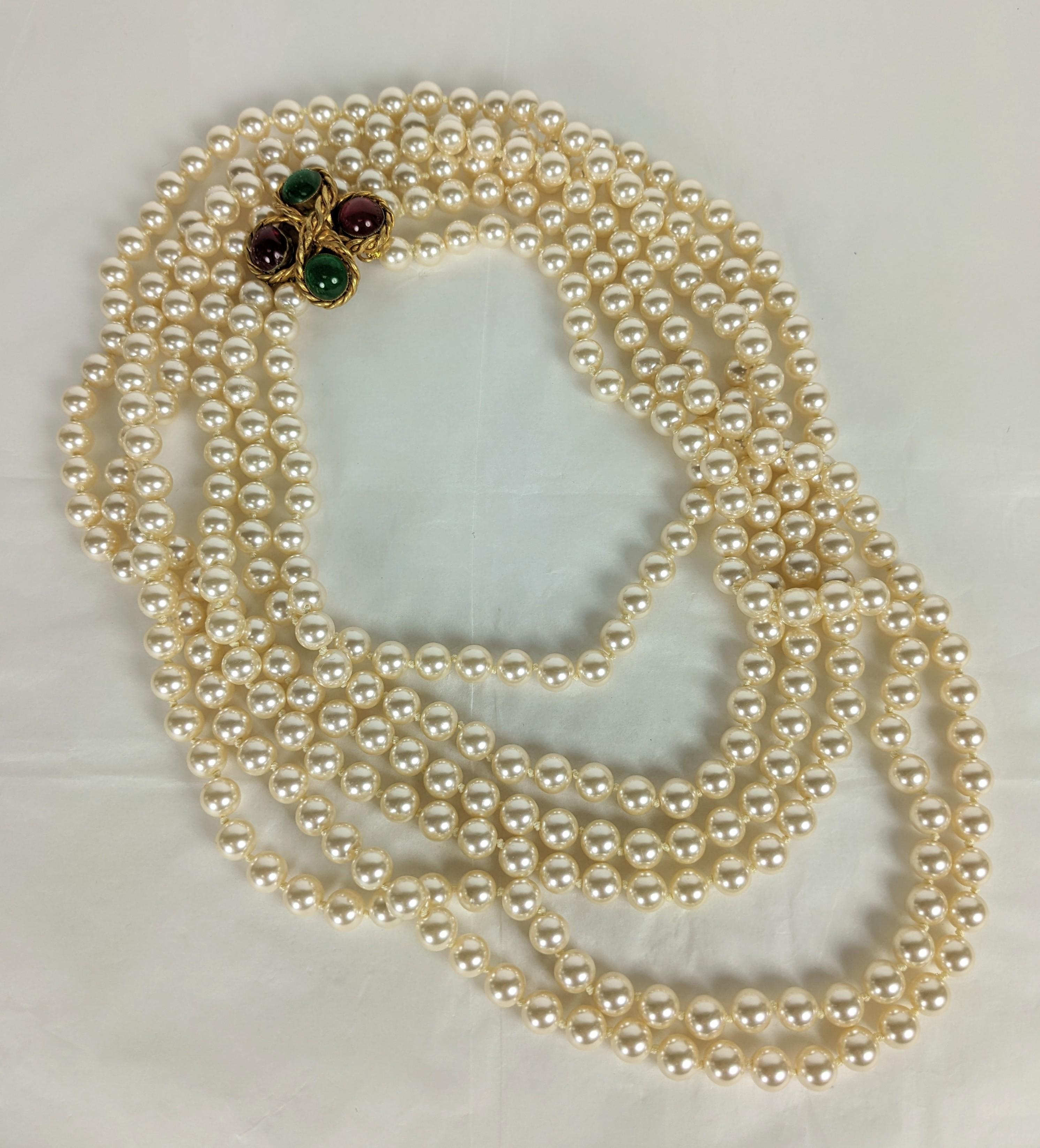 Incredibly Versatile Chanel Double Strand Pearl Necklace from the 1980's. Super long hand knotted faux pearls with hand made bronze cruciform hand poured glass clasp by Maison Gripoix, Paris. Unsigned early design. Early 1980's France. 60