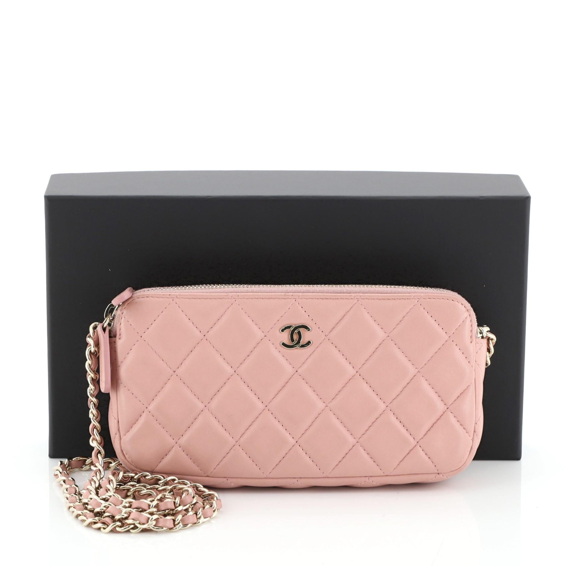 This Chanel Double Zip Clutch with Chain Quilted Caviar, crafted in pink quilted caviar leather, features a detachable woven-in leather chain strap, front CC logo and gold-tone hardware. Its double zip closures and an open center compartment