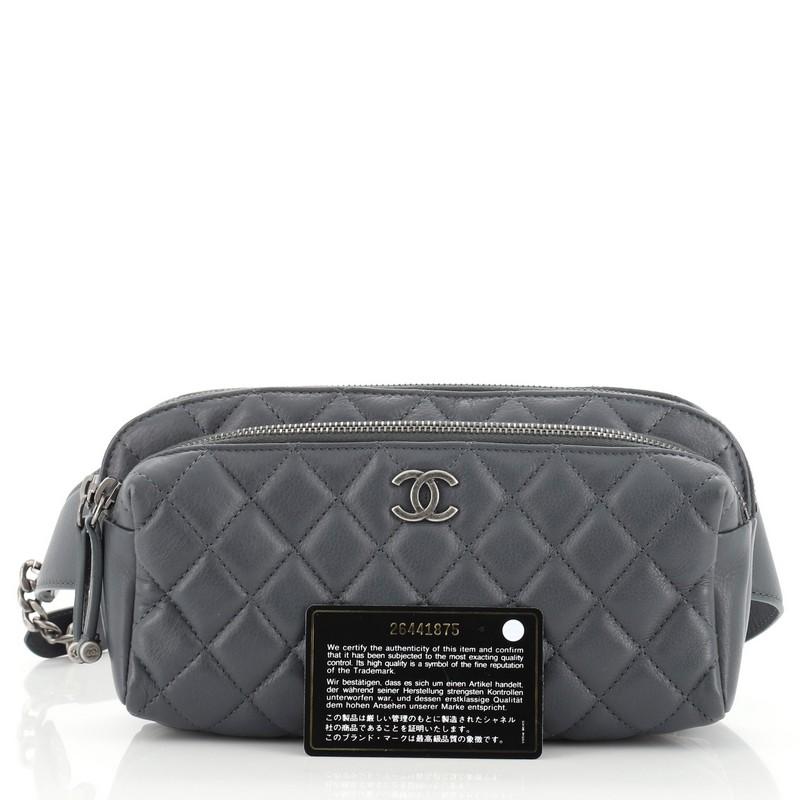 This Chanel Double Zip Waist Bag Quilted Calfskin, crafted in blue quilted calfskin, features an adjustable belt strap, exterior front zip compartment, and aged silver-tone hardware. Its zip closure opens to a gray fabric interior. Hologram sticker
