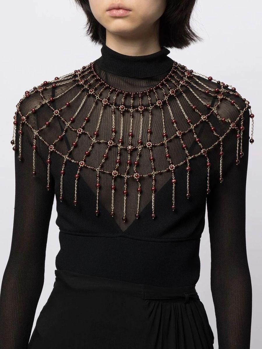 Crafted in France, this one-of-a-kind dramatic Chanel necklace from 2016 features red gripoix beads draped all around, covering you from shoulders to waist. For an added touch of timeless sophistication, the necklace has two snap closures on the