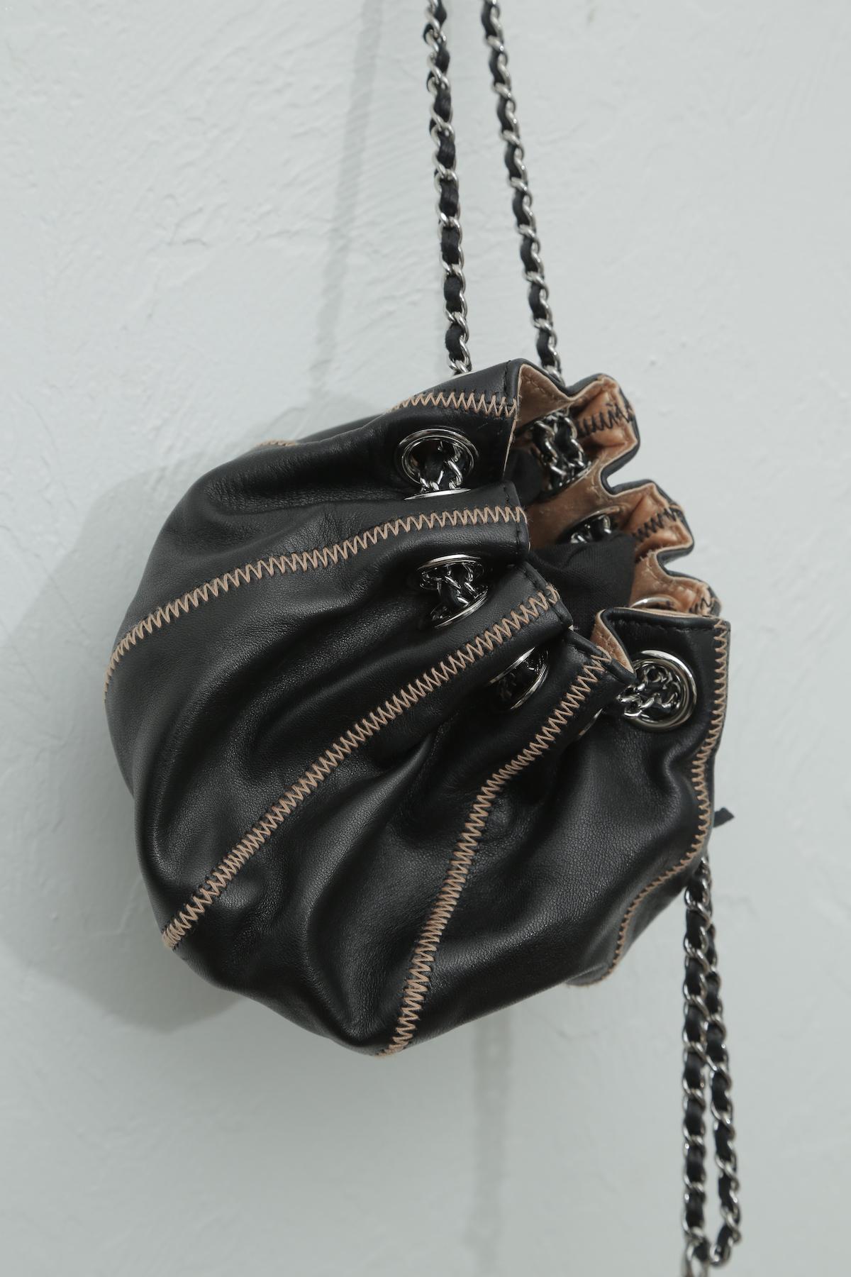 Like new
This item may have been worn but has no visible signs of wear.

Description:
This stylish pouch is rafted of luxuriously soft lambskin leather in black. This bag is stitched in a sac form with light pink stitching. The bag features silver