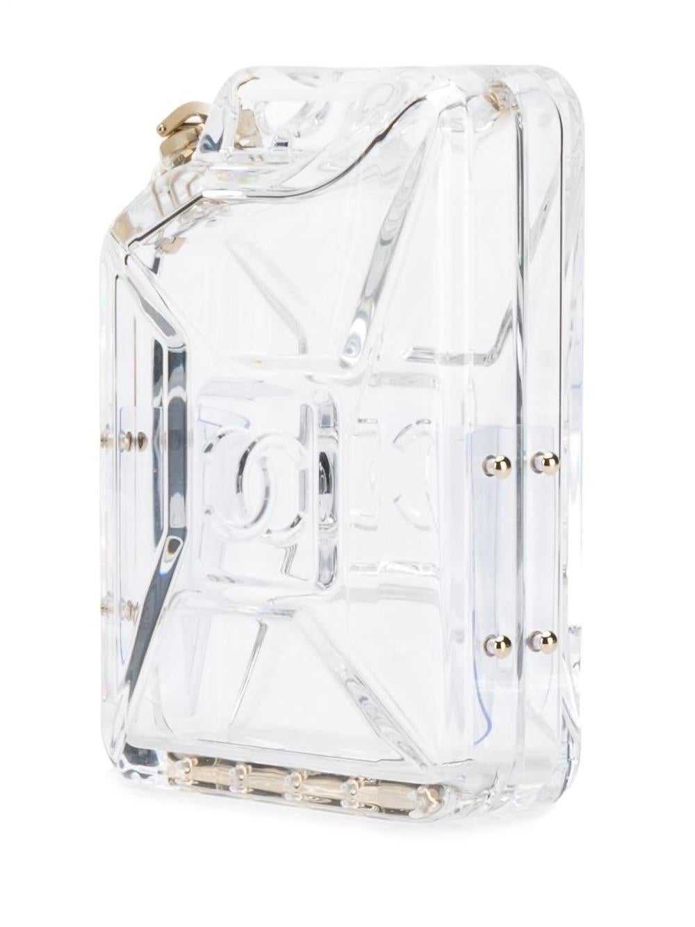 A piece that immediately sold out after debuting at Chanel's Dubai by Night Cruise 2015 show, this Chanel miniaudière is a spectacular collector's item. The hard-cased clutch in the shape of a gas tank is formed in clear, monogrammed plexiglass and