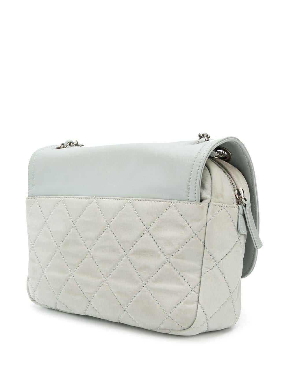 Crafted in Italy from iridescent microfiber nylon in a soft shade of duck-egg blue, this pre-owned Chanel quilted flap bag features the classic CC turn-lock accented by gunmetal hardware, a matching duck-egg blue. lambskin leather fold-over top and