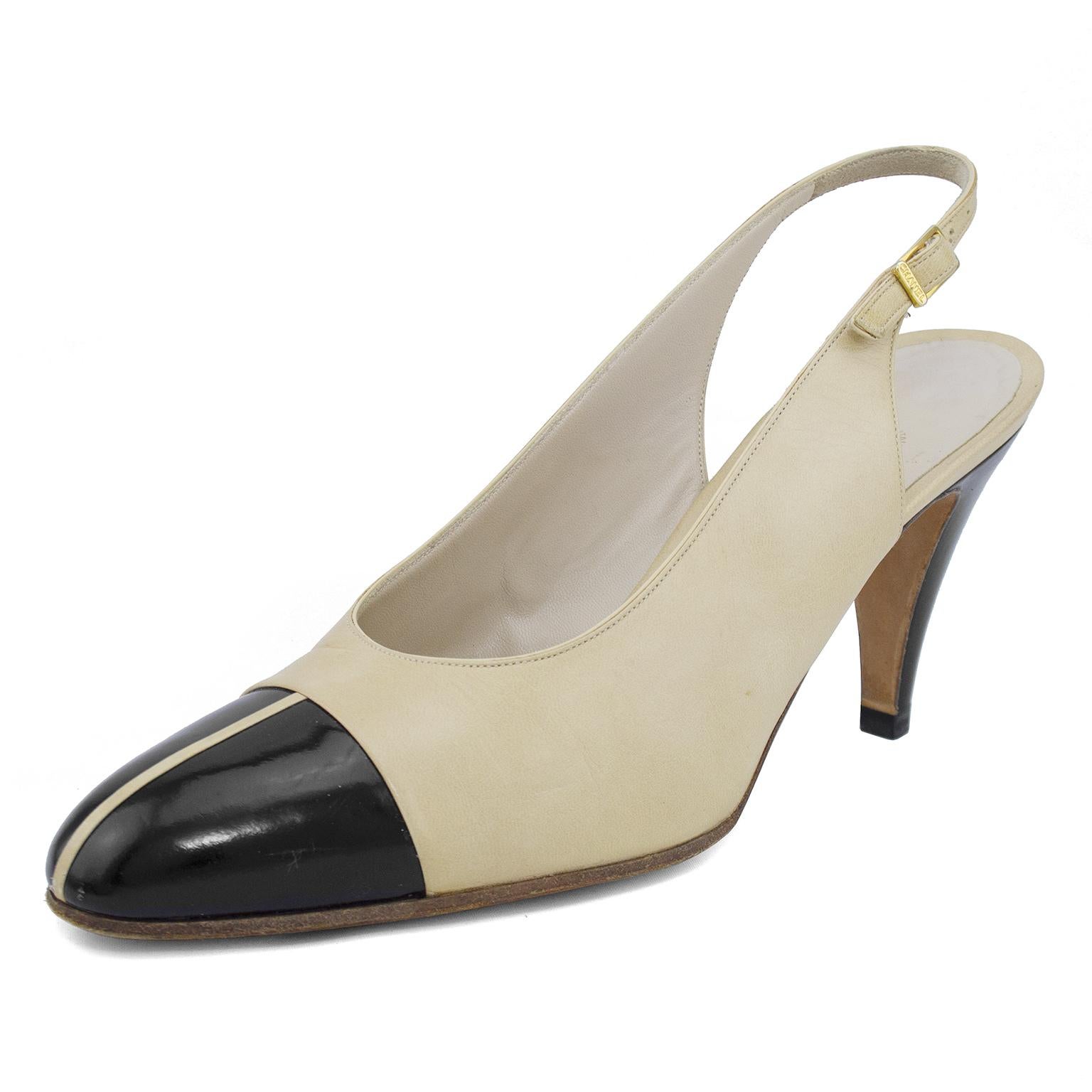 Early 1990s Chanel slingbacks. Beige leather with contrasting black leather cap toe. Slightly mod inspired with a vertical beige line down the centre of the black cap toe. Cream leather interior with metallic gold brand stamp. Gold-tone branded