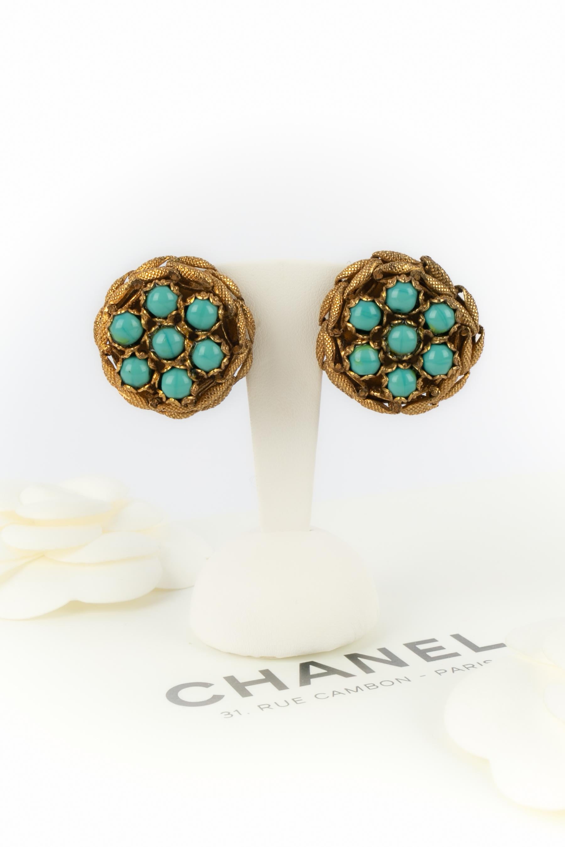 Chanel - (Made in France) Orecchini a clip in metallo dorato battuto che rappresentano una corona di alloro, centrata da perle in pasta di vetro di colore turchese. Non firmato. Opere dell'Atelier A di Denez del 1970 circa.

Condizioni:
Ottime