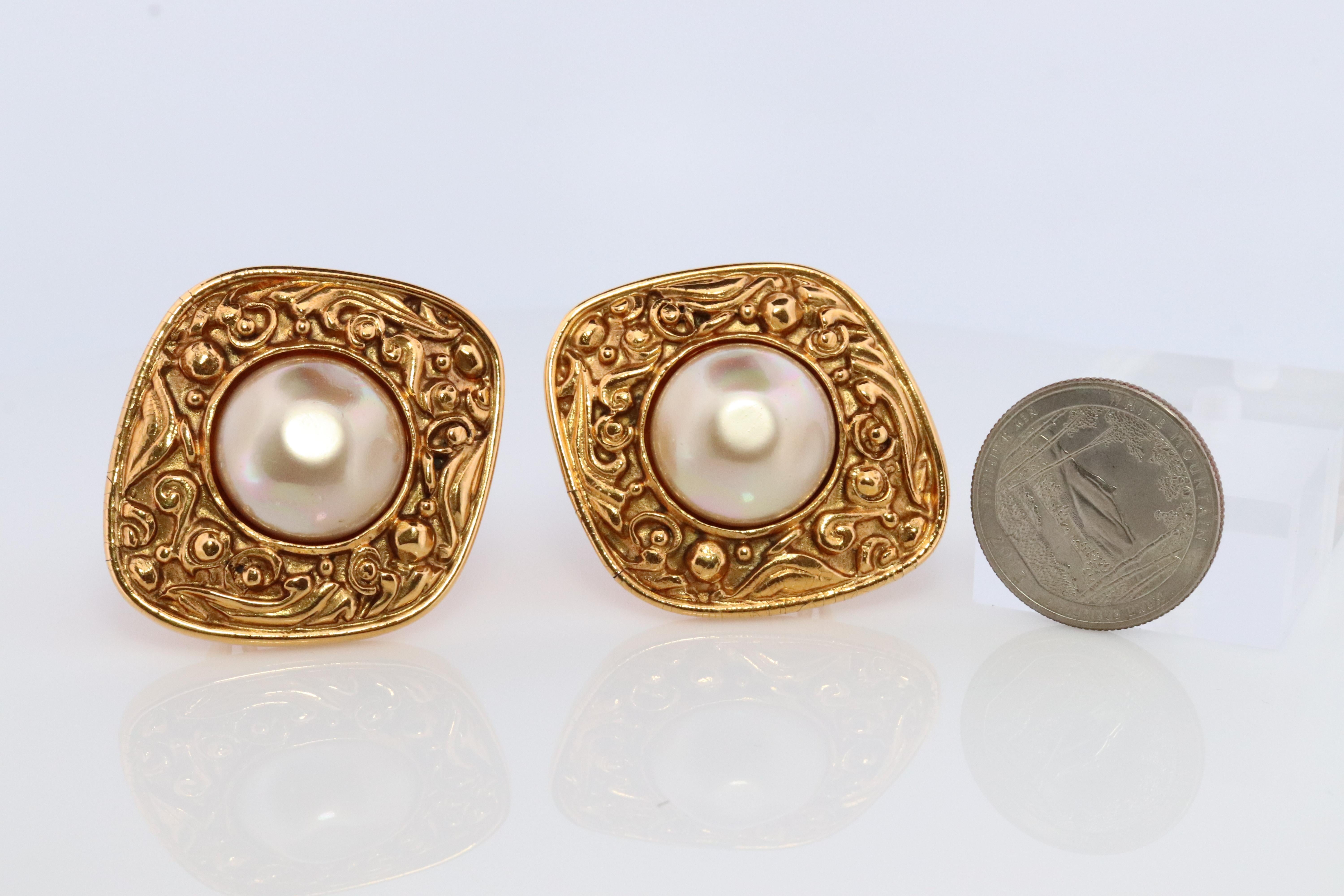 Genuine Chanel Earrings
Non-Pierced Omega Clip on Earrings.
Imitation Large Mabe pearl set into Byzantine style earrings.

Large and Heavy

Details:
42mm by 37mm shields
17mm pearls
Please ask for additional pictures and questions.