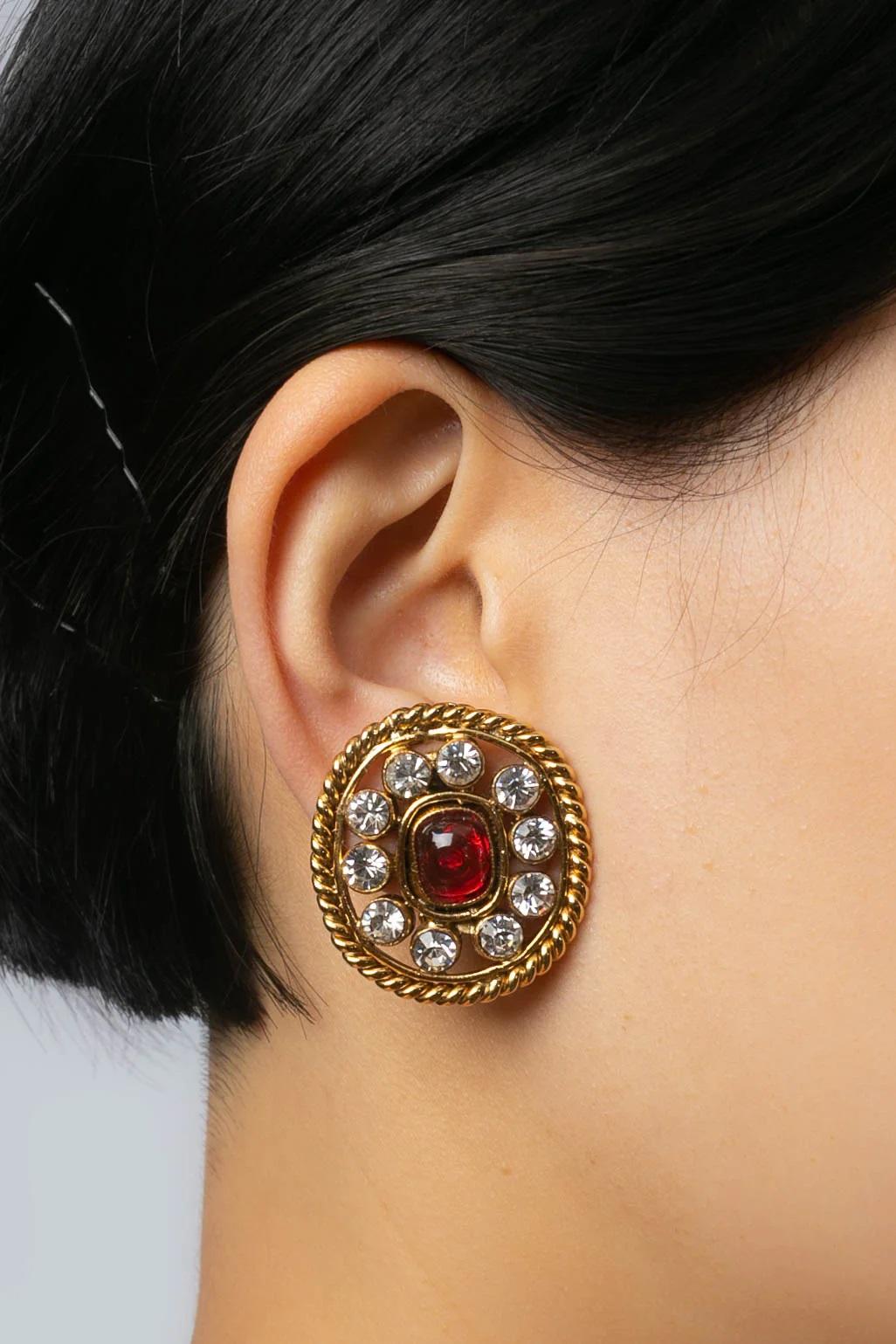 Chanel- (Made in France) Clip on gilded metal earrings decorated with rhinestones and a red glass paste cabochon.

Additional information:

Dimensions: 
3.2 W x 3.5 H cm (1.25