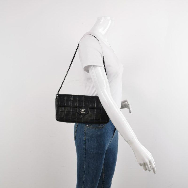 Chanel East West Chocolate Bar Black Leather Silver Hardware, 2000-2002
 These are professional photos of the actual bag.
 This charming Vintage Chanel East West Leather Shoulder Bag is a stylish mix of classy and casual. The elongated shape gives