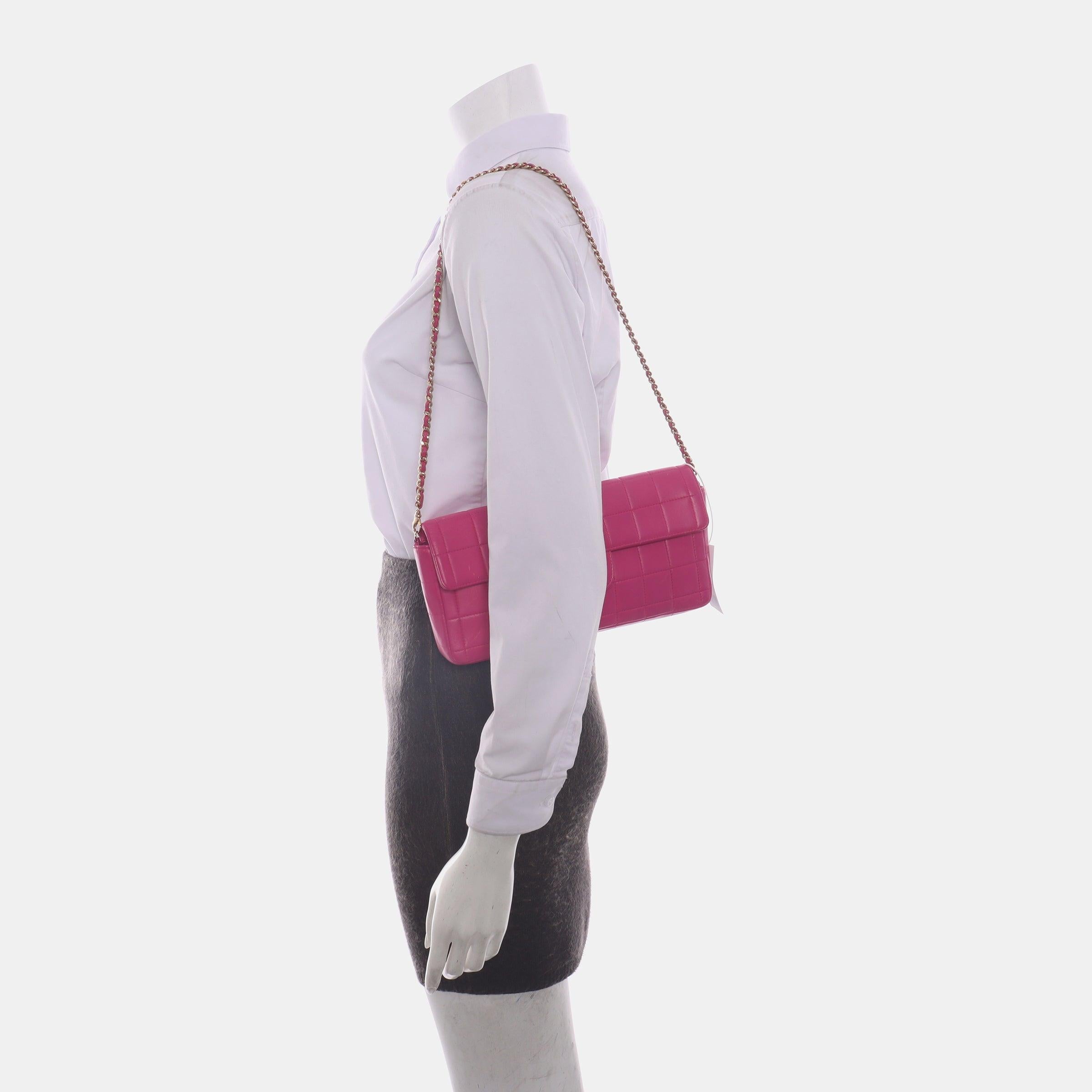 Chanel East West Chocolate Bar Fuchsia Pink Leather 24k Gold hardware
 These are professional photos of the actual bag offered by Luxbags.
 This charming Vintage Chanel East West Leather Shoulder Bag is a stylish mix of classy and casual. The