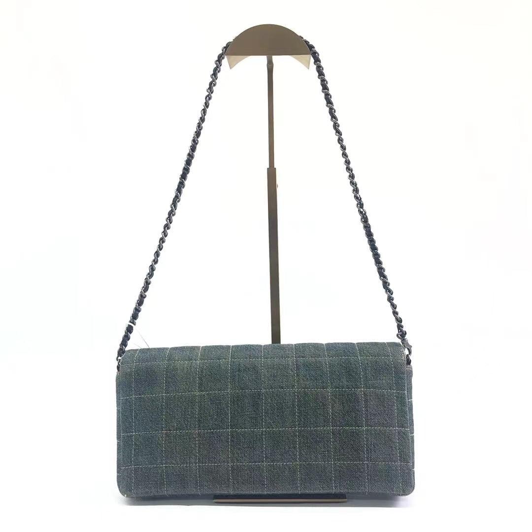 Chanel East West Chocolate Bar Green Denim with Leather Lining Shoulder Bag
These are professional photos of the actual bag.
  This charming Vintage Chanel East West Denim Shoulder Bag is a stylish mix of classy and casual. It's crafted from denim