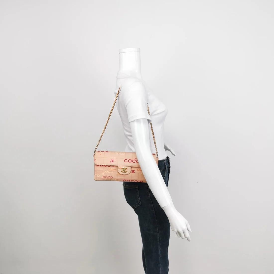 Chanel East West Chocolate Bar Pink Denim with Coco Prints These are professional photos of the actual bag offered by Luxbags. This charming Vintage Chanel East West Denim Shoulder Bag is a stylish mix of classy and casual. Its coral pink denim with