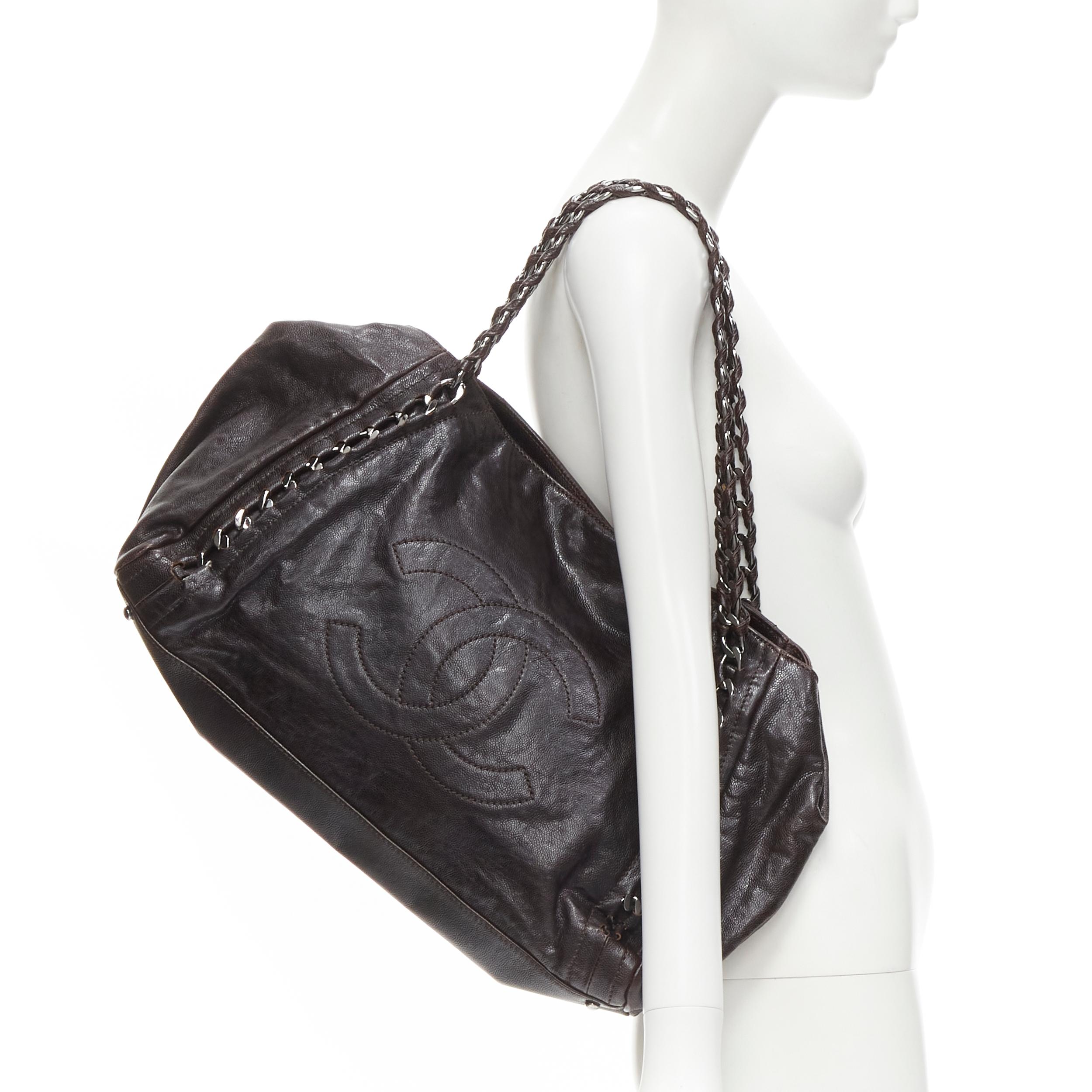 CHANEL East West dark brown grained leather CC logo chunky silver chain hobo bag 
Reference: GIYG/A00243 
Brand: Chanel 
Designer: Karl Lagerfeld 
Model: East West tote 
Material: Leather 
Color: Brown 
Pattern: Solid 
Closure: Magnetic 
Extra