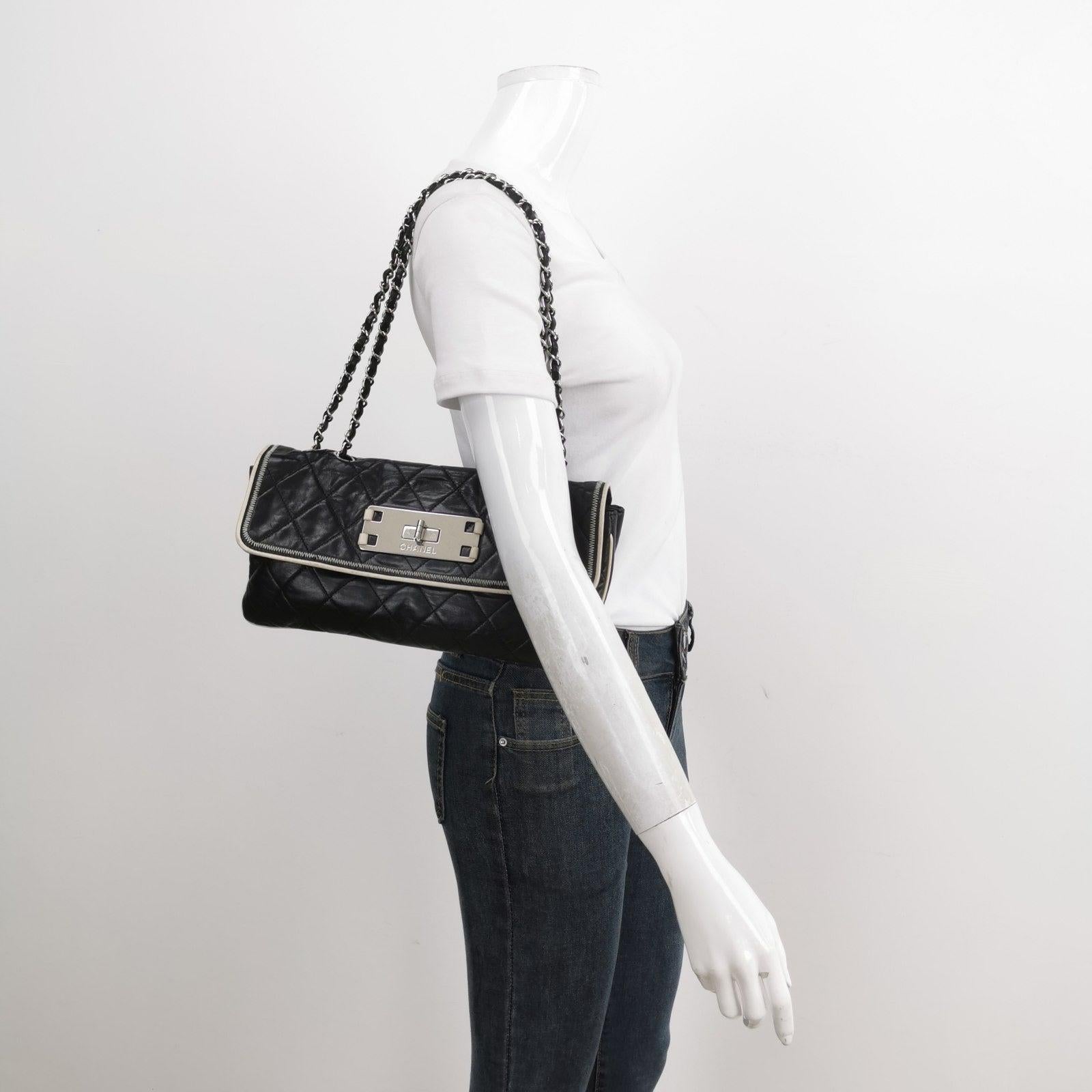 Chanel East West Mademoiselle Flap Bag 2008 Medium Black Leather Shoulder Bag These are professional photos of the actual bag offered by Luxbags. This charming Vintage Chanel East West Mademoiselle Flap Shoulder Bag is a stylish mix of classy and