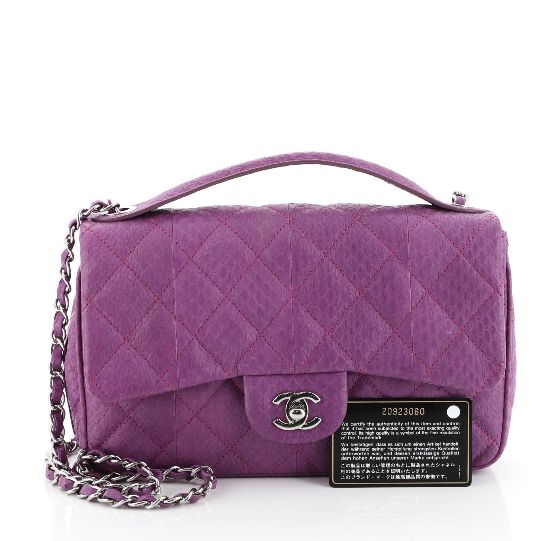 This Chanel Easy Carry Flap Bag Quilted Snakeskin Medium, crafted in purple snakeskin, features a top handle, woven-in leather chain strap, exterior back slip pocket and silver-tone hardware. Its turn-lock closure opens to a purple satin interior.