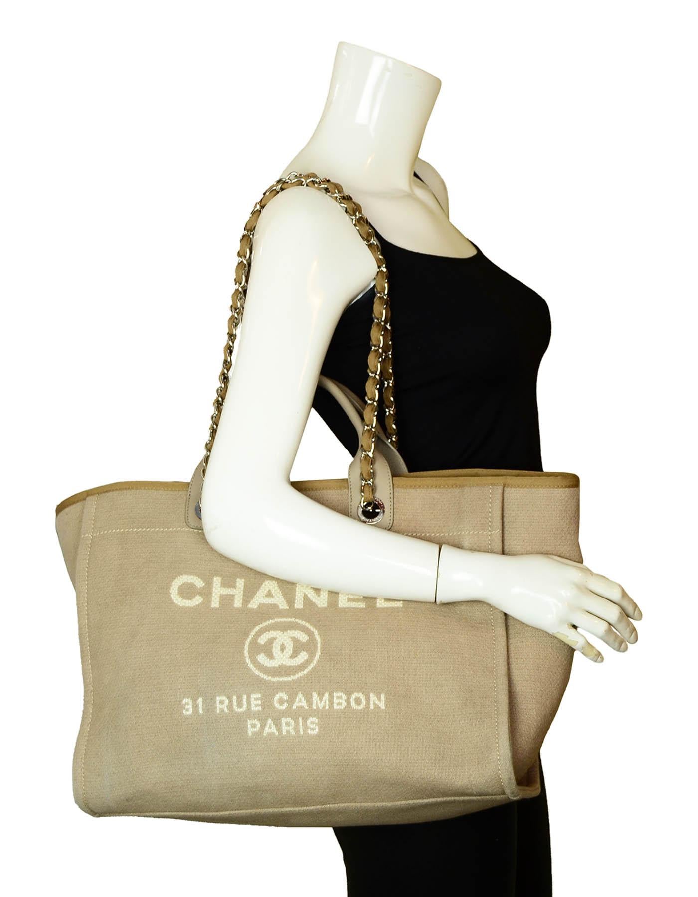 Chanel Ecru Beige Canvas Medium Deauville Tote Bag

Made In: Italy
Year of Production: 2017
Color: Beige
Hardware: Silvertone
Materials: Canvas with leather trim
Lining: Beige textile
Closure/Opening: Open top with center magnet
Exterior Pockets: