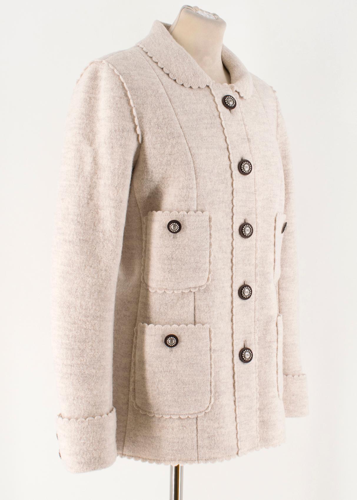 Chanel Ecru Wool Scalloped Detail Jacket

- Pure wool in an ecru shade
- Scalloped detail around the cuffs, collar, pockets, hem, shoulder and button placket
- Four buttoned patch pockets on the front  
- Button fastening
- Beautiful intricate
