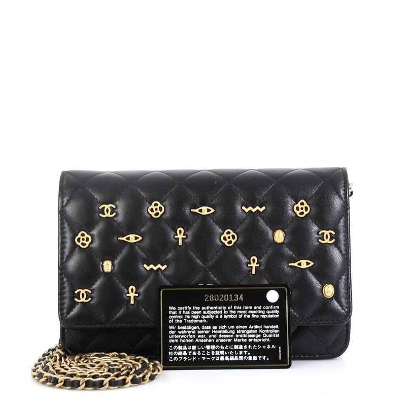 This Chanel Egyptian Amulet Wallet on Chain Quilted Lambskin, crafted from black quilted lambskin leather, features woven in leather chain strap, Egyptian charms, and gold-tone hardware. Its flap opens to a black leather and fabric interior.