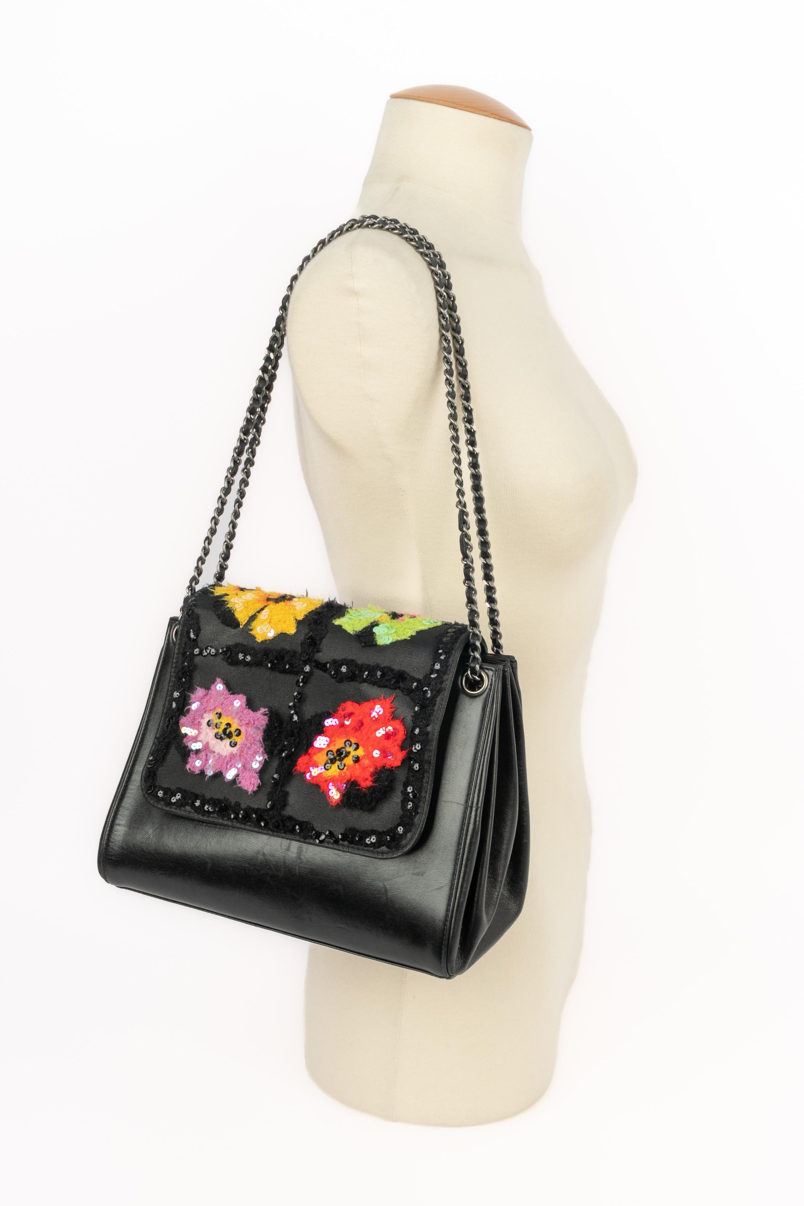 CHANEL - (Made in France) Black lamb leather bag with an organza lay embroidered with sequins and tweed. Black lamb leather lining. Piece with an authenticity card and a serial number. 2000 Fall-Winter Collection under the artistic direction of Karl